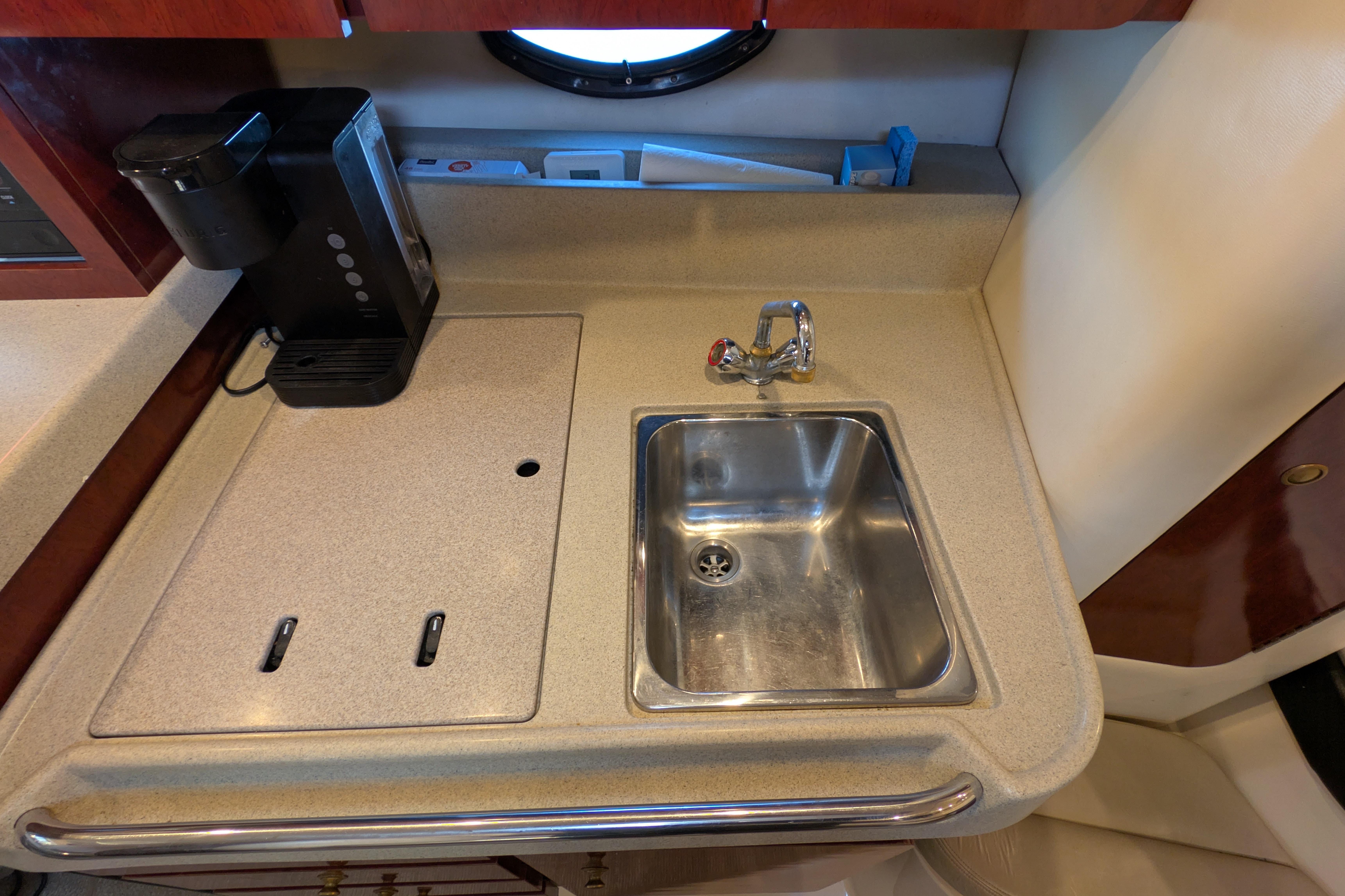 2001 Wellcraft 3300 Martinique yacht kitchenette with sink and coffee maker.