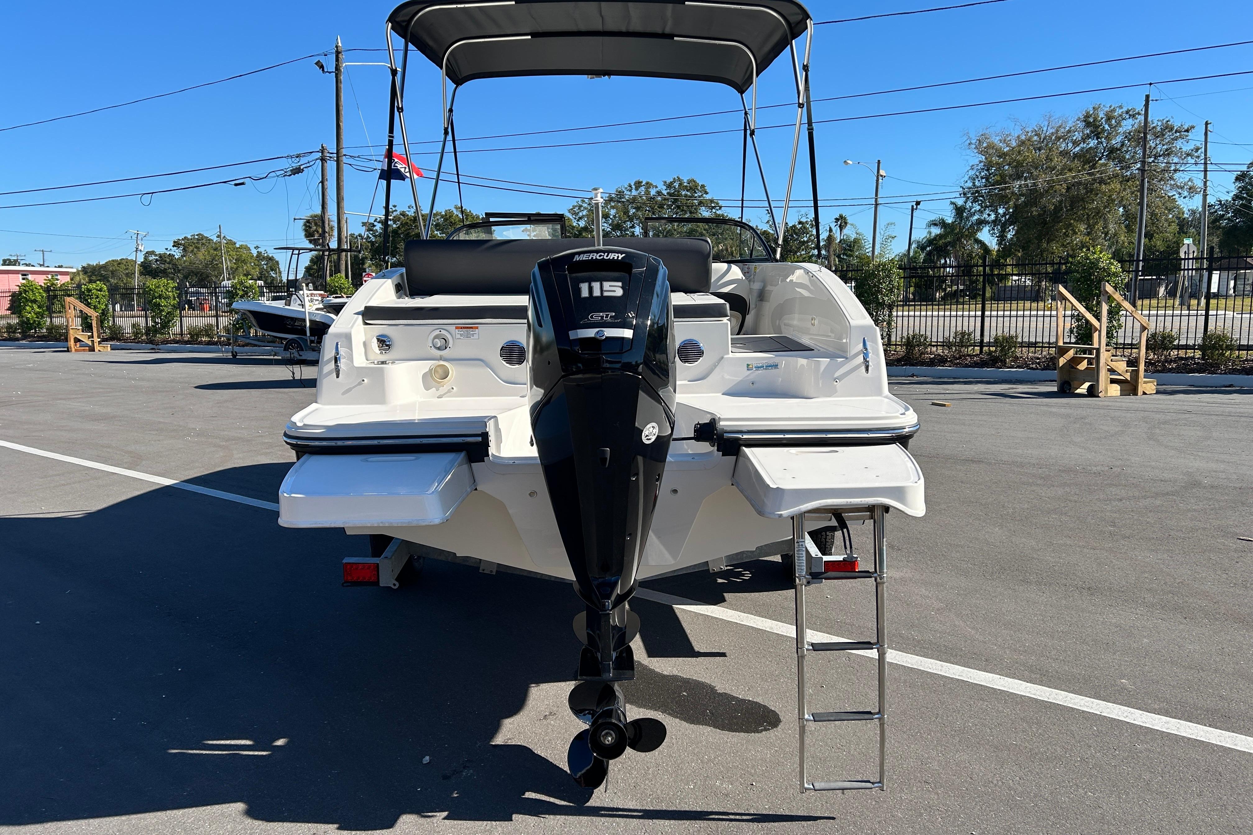 2020 Bayliner DX 2000 boat with Mercury 115 engine, parked outdoors.
