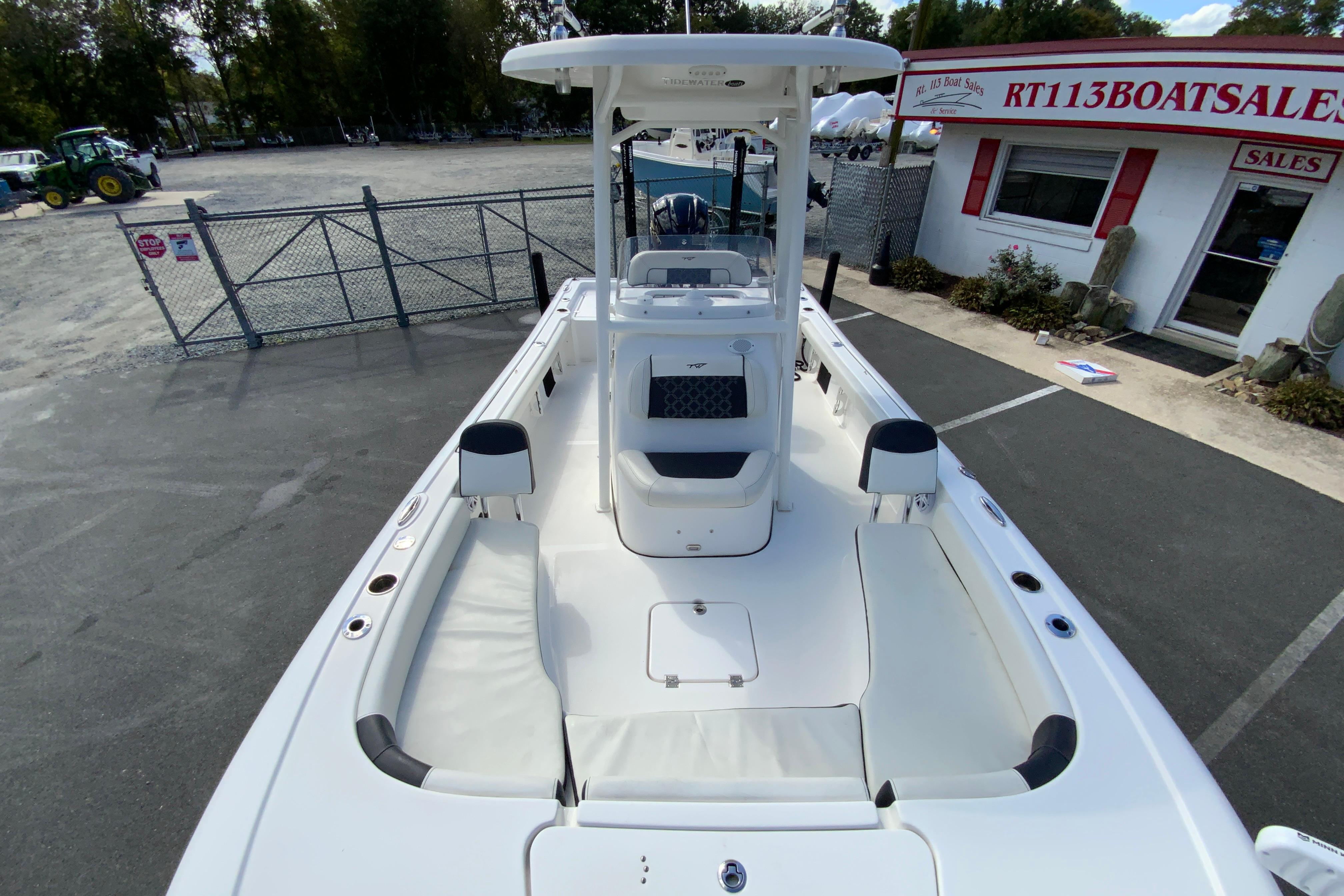 2022 Tidewater 2300 Carolina Bay boat at dealership, showcasing spacious deck and seating.