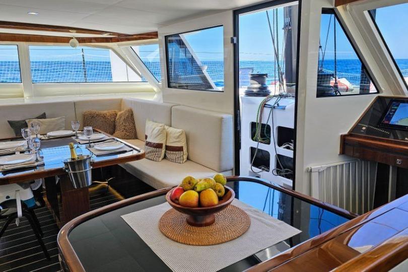 Luxurious interior of 2016 HH Catamarans HH66 with elegant dining area and ocean view.