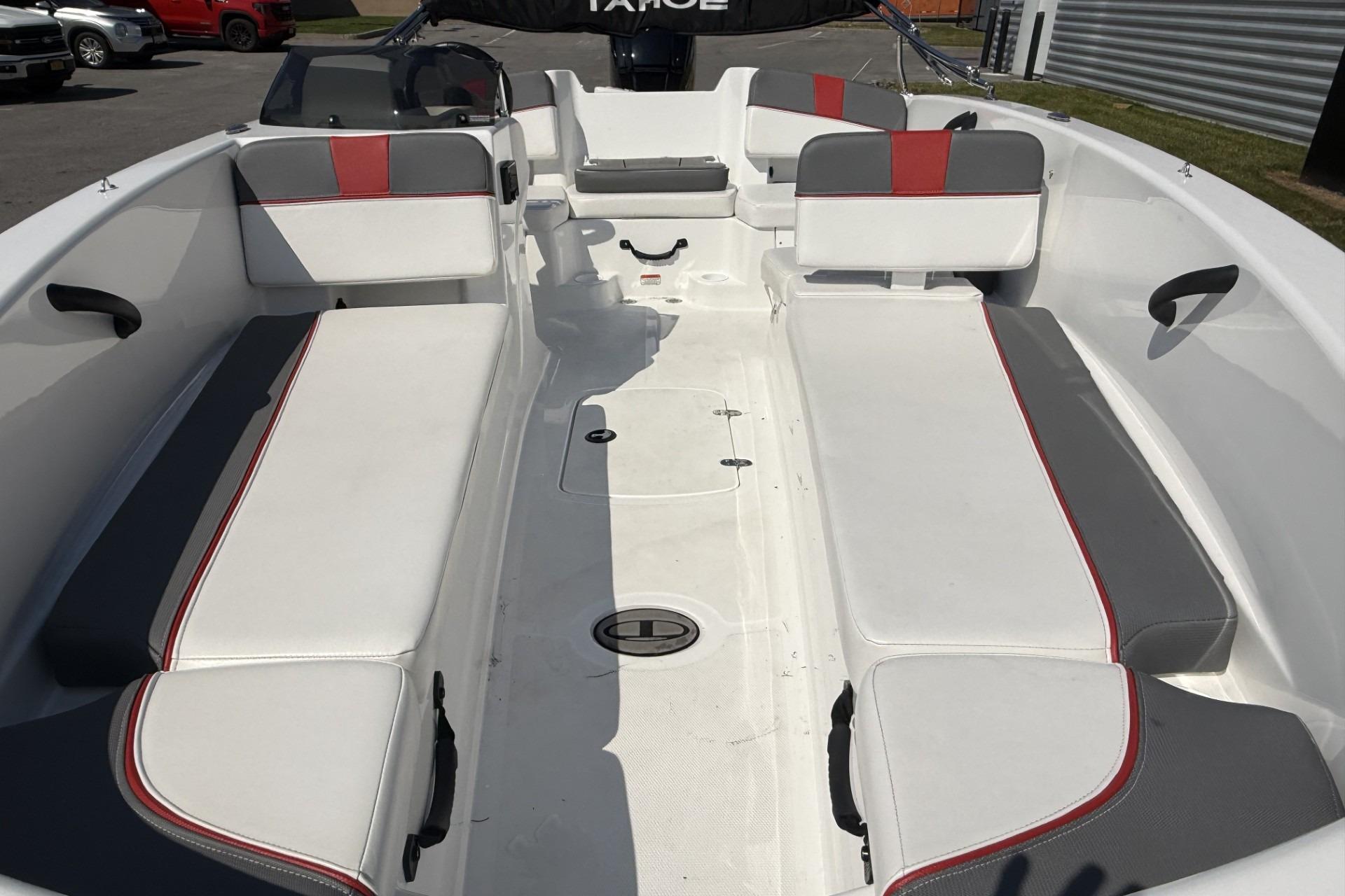 2024 Tahoe T18 boat interior with white and gray seating, red accents.