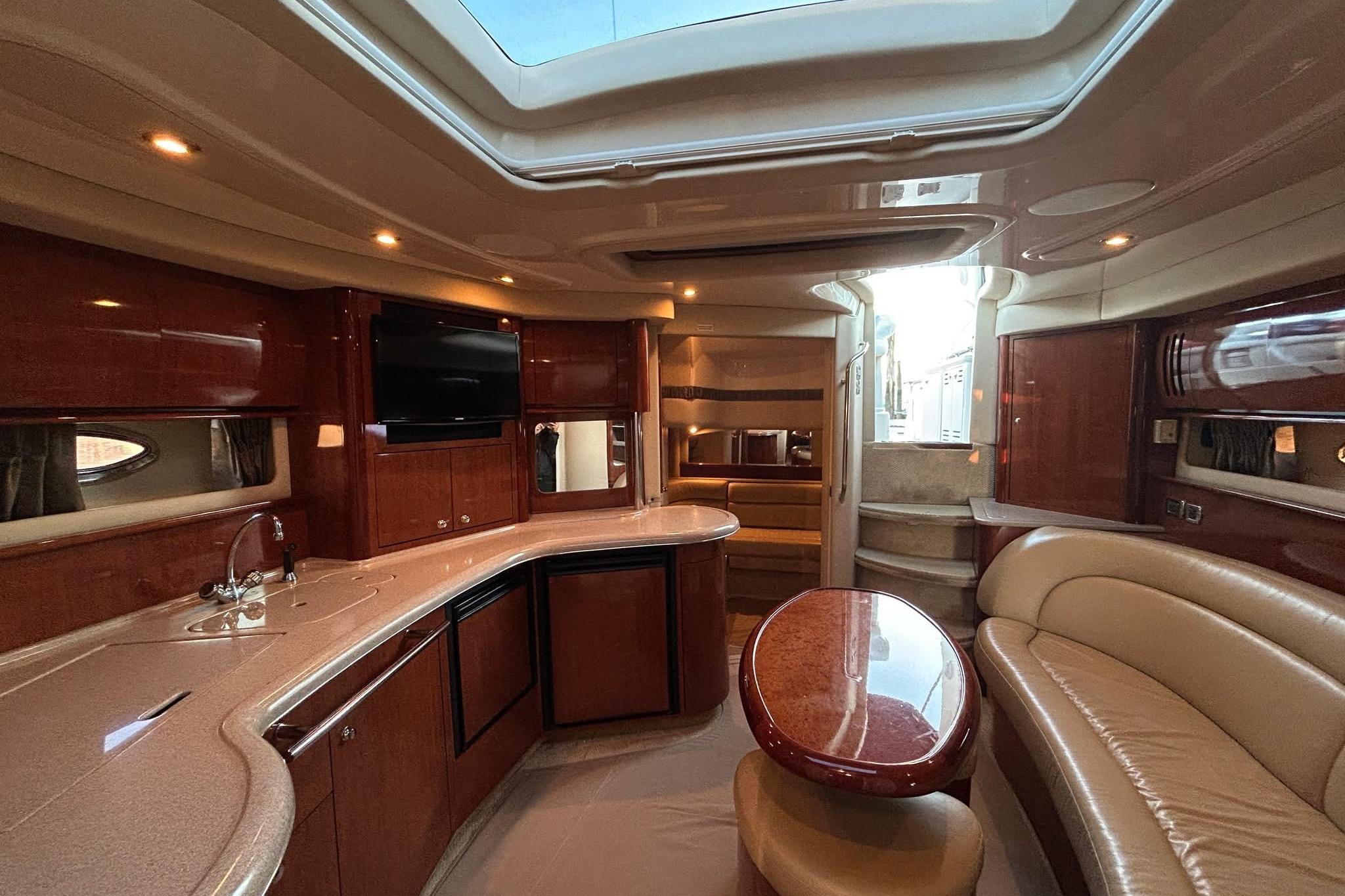 Luxurious interior of a 2003 Sea Ray 420 Sundancer yacht with elegant wood finishes.