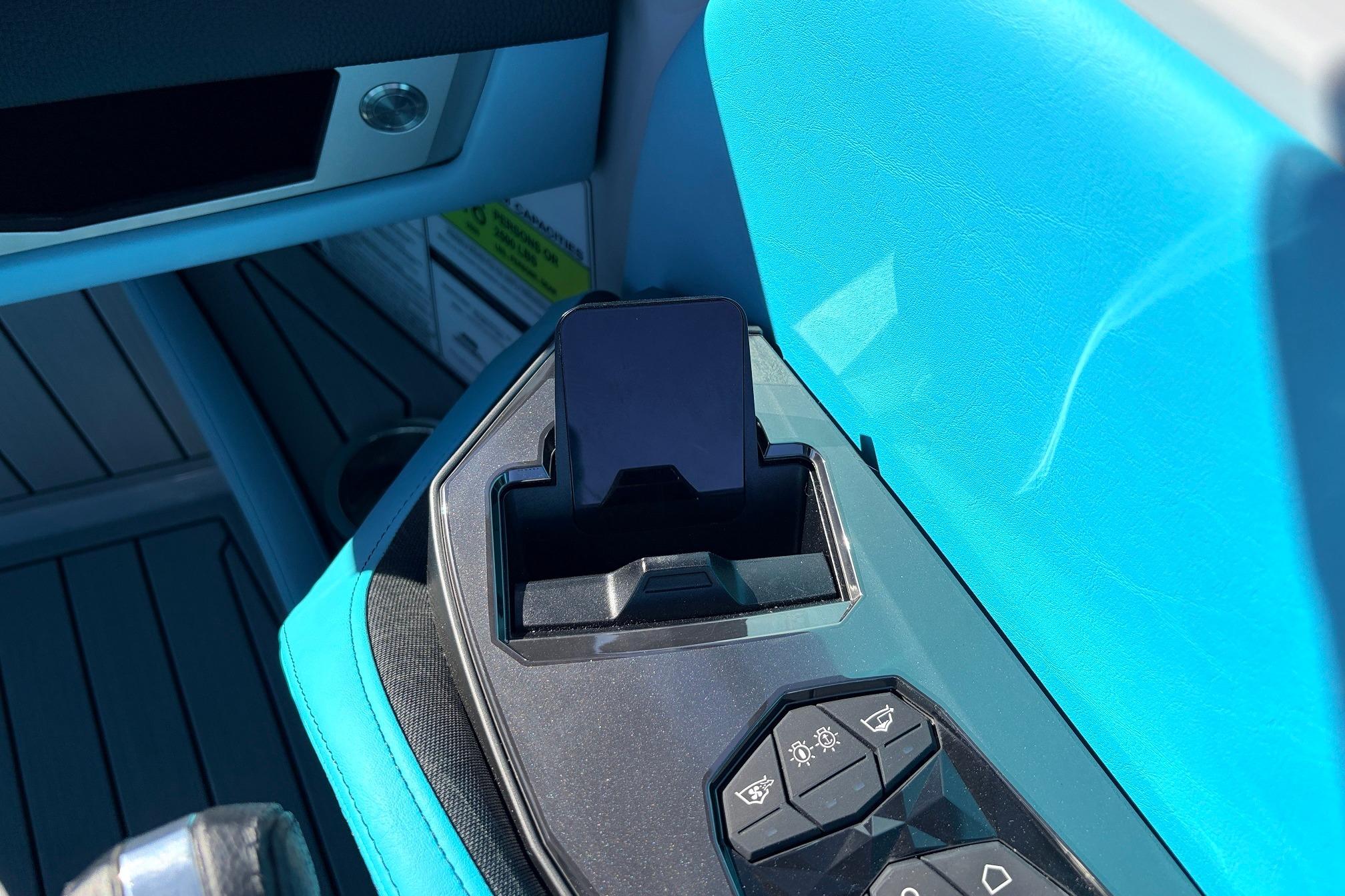 Interior of 2026 Nautique Super Air Nautique G23 with phone holder and control panel.