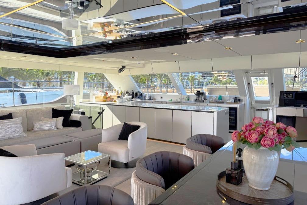 Luxurious interior of 2024 Sunreef 80 Power yacht with elegant seating and modern kitchen.