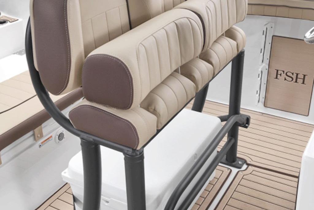 2026 Yamaha Boats 255 FSH Sport E interior seating with beige and brown upholstery.