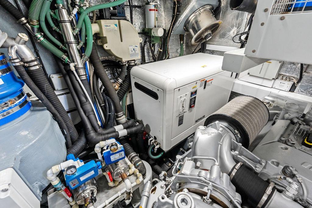 Engine room of 2012 Sunseeker 88 Yacht, featuring Kohler generator and complex piping system.
