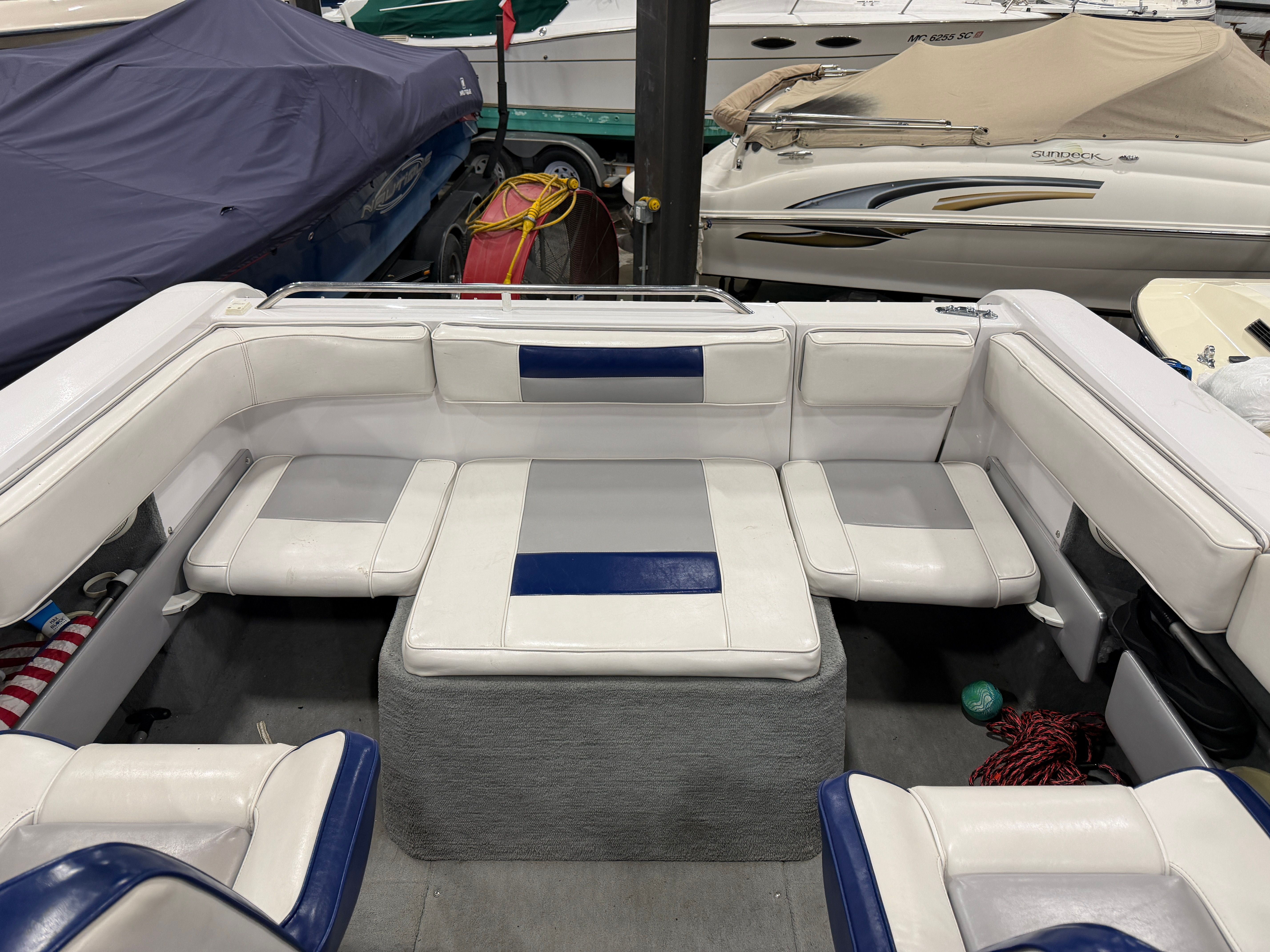 Interior of a 1992 Four Winns 225 Sundowner with white and blue seating.