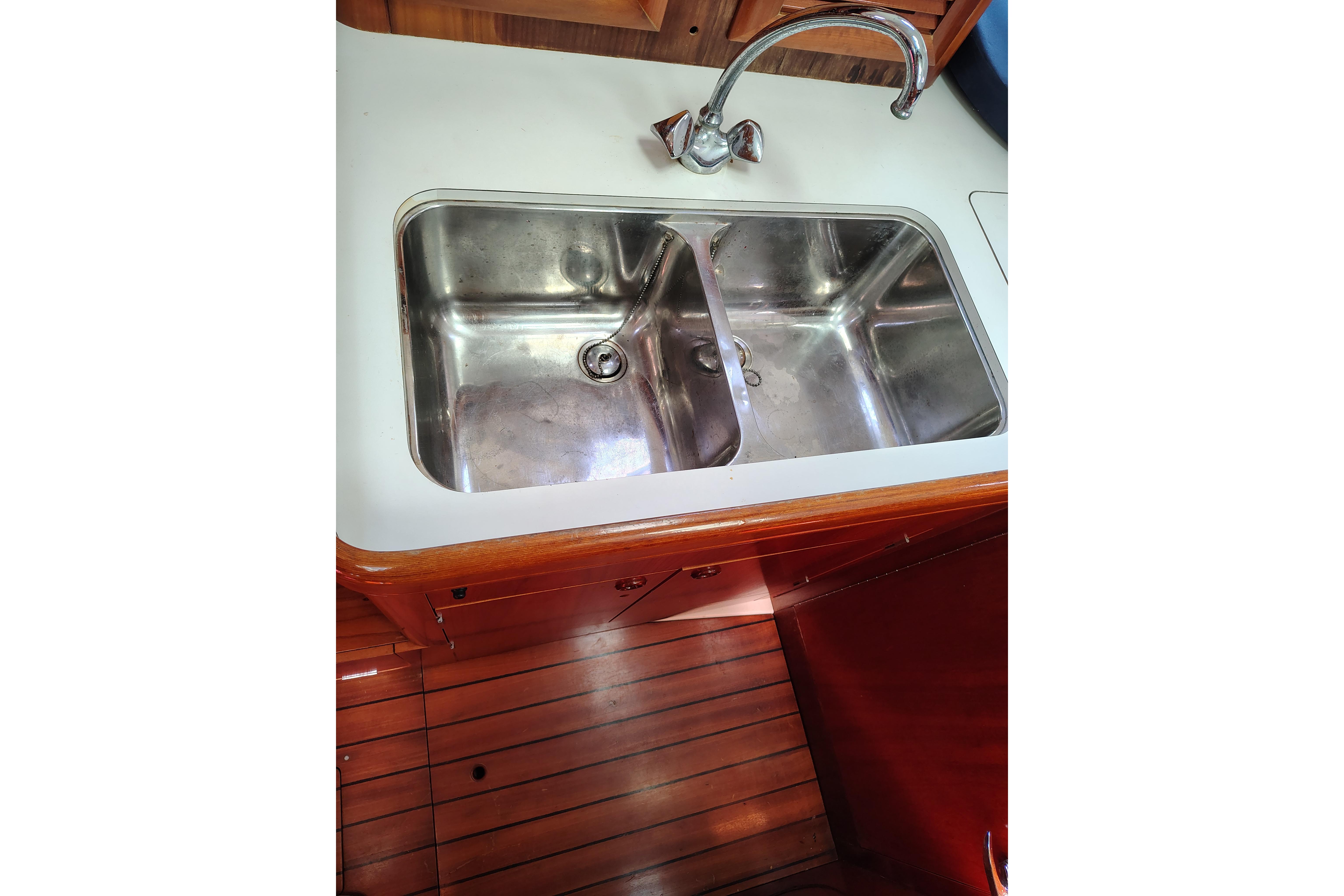 Stainless steel double sink in 2001 Beneteau Oceanis 411 yacht kitchen.