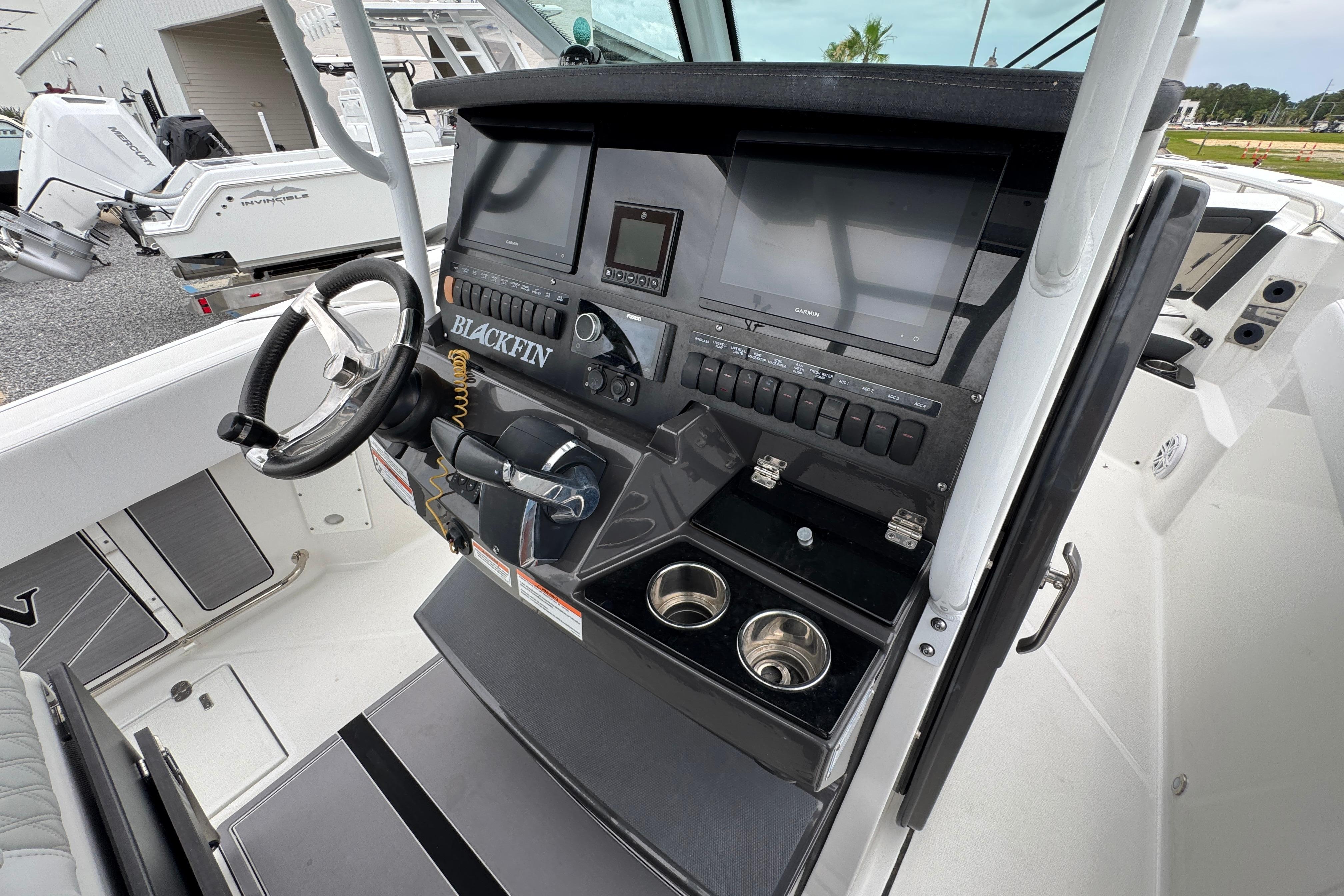 2023 Blackfin 272 CC boat dashboard with steering wheel and electronic controls.