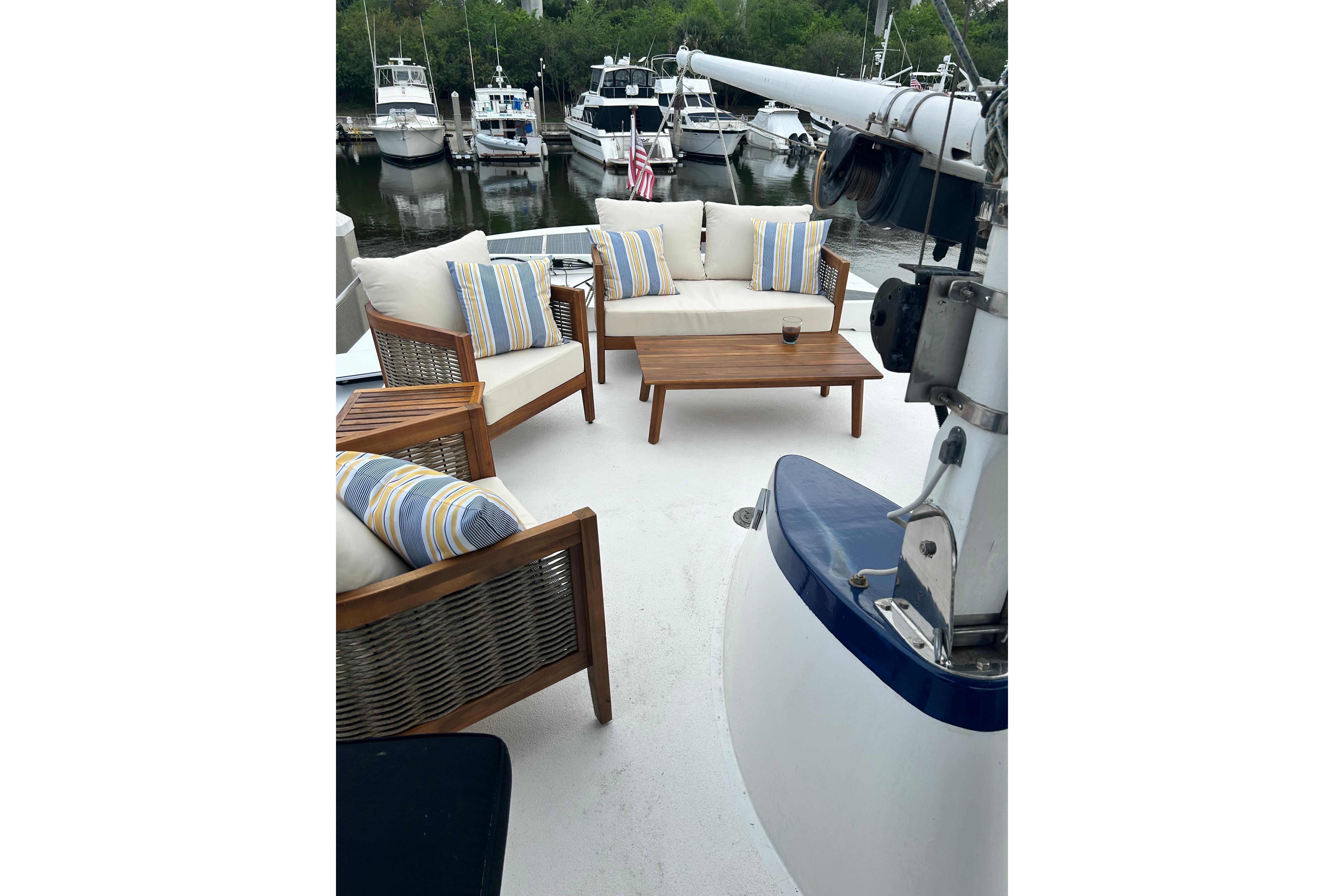 1979 Cheoy Lee 46 LRC yacht deck with outdoor seating and table.