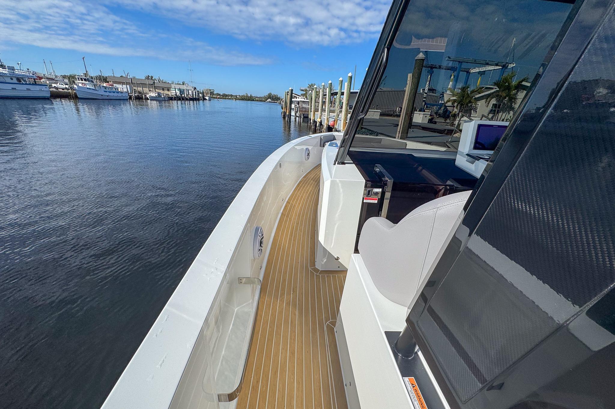 2026 De Antonio Yachts D42 docked, showcasing sleek design and spacious deck.