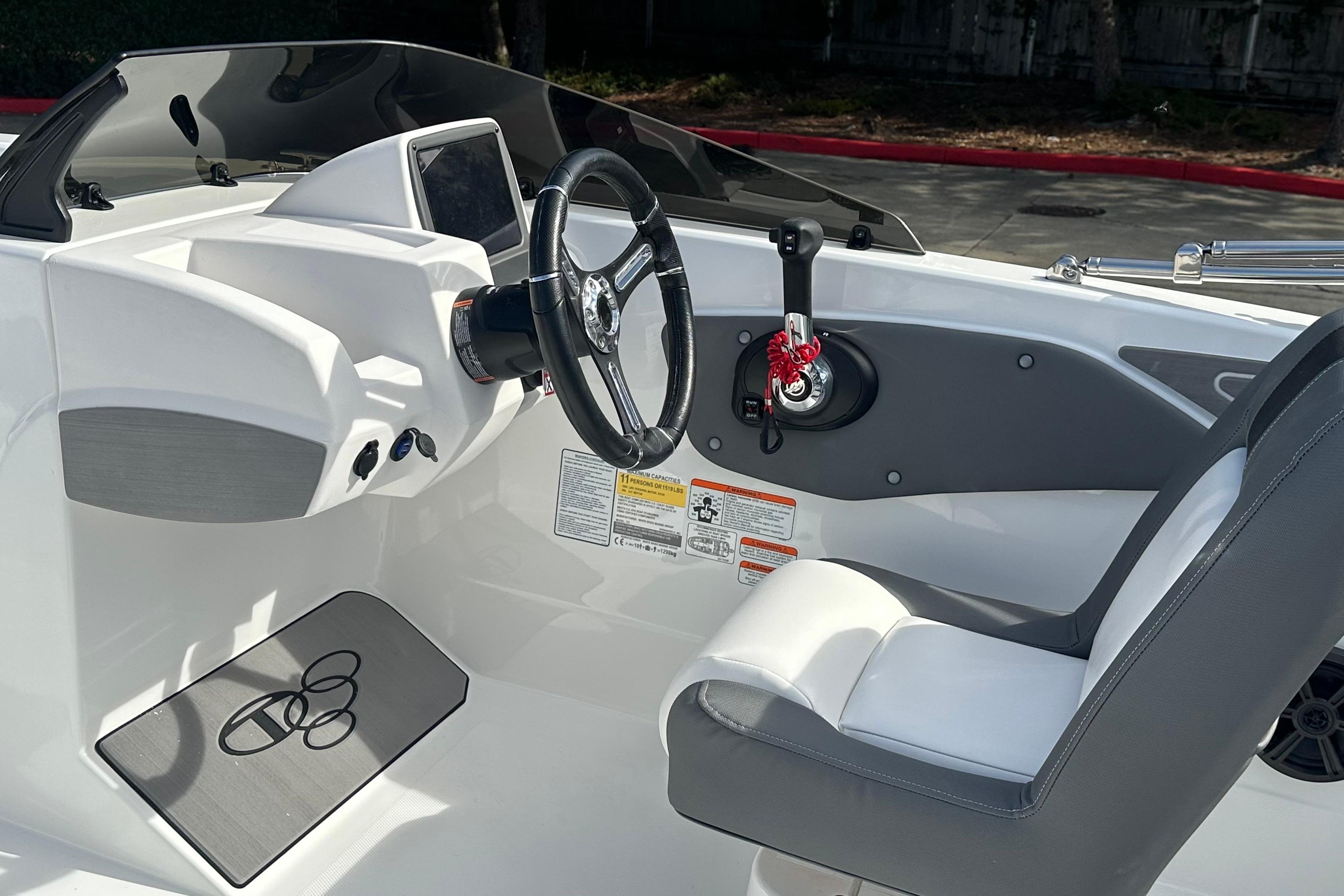 2026 Tahoe T21 boat cockpit with steering wheel and control panel.