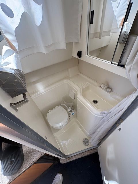 Bathroom in 2008 Bayliner Discovery boat with toilet and sink.