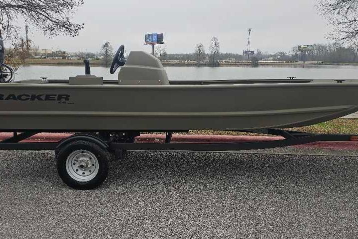 2026 Tracker Grizzly 1648 SC boat on trailer by a lake.