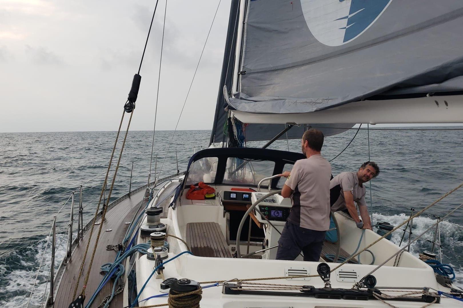 Sailing on a 1992 Nautor Swan 55 yacht with two people navigating the open sea.