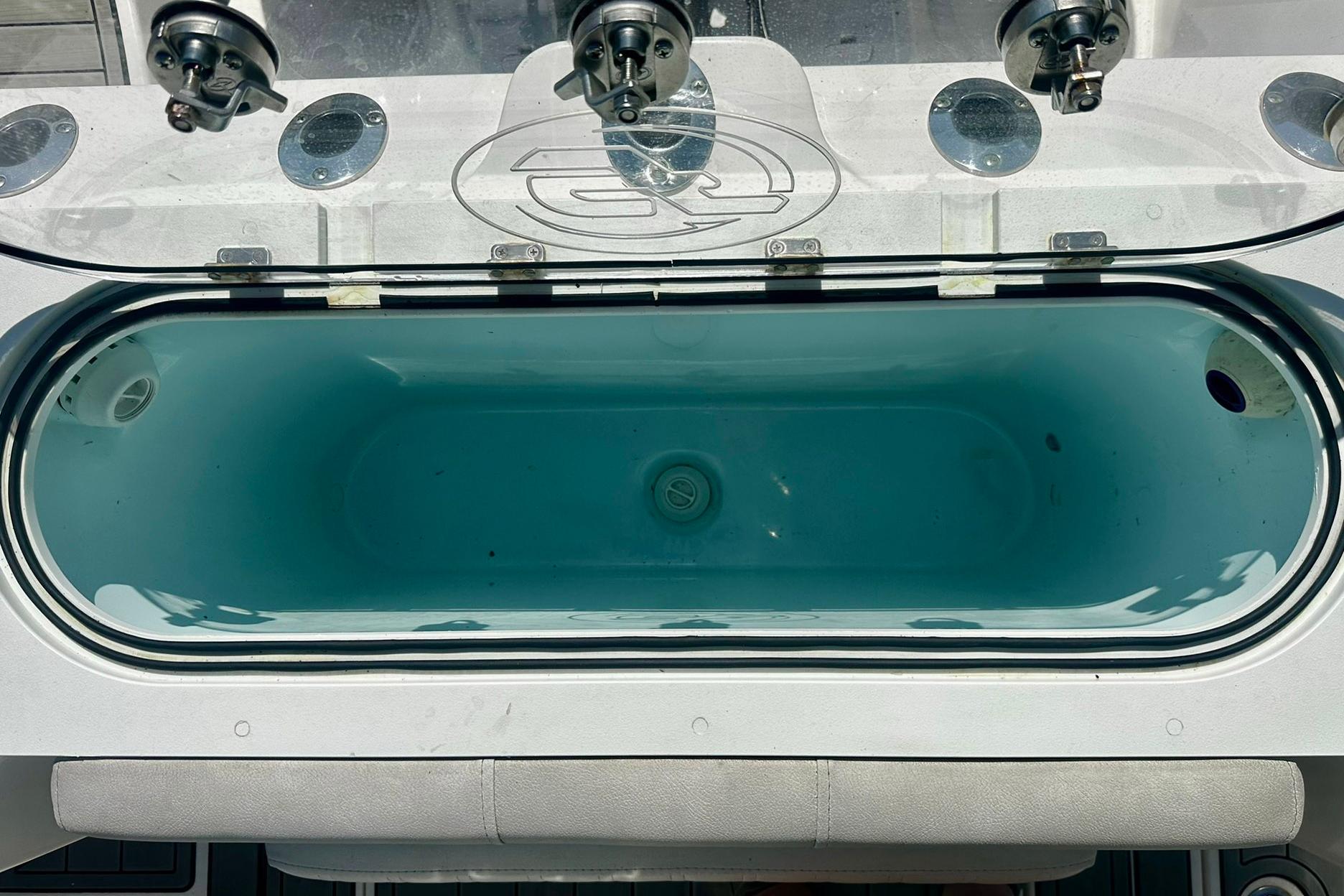 Livewell on a 2002 Sea Fox 228 Commander boat, featuring rod holders and clear lid.