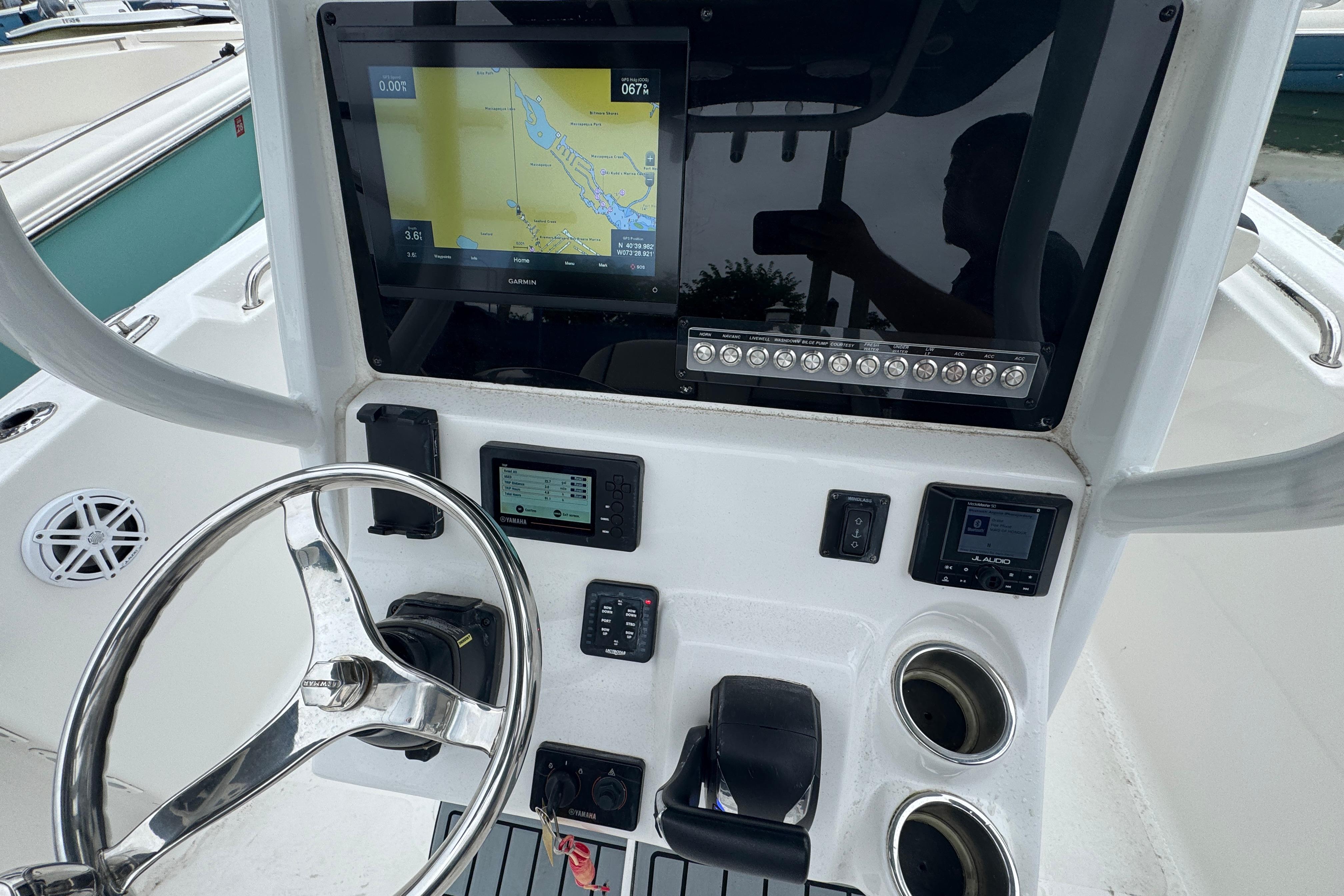 2022 Tidewater 232 SS boat dashboard with navigation screen and controls.
