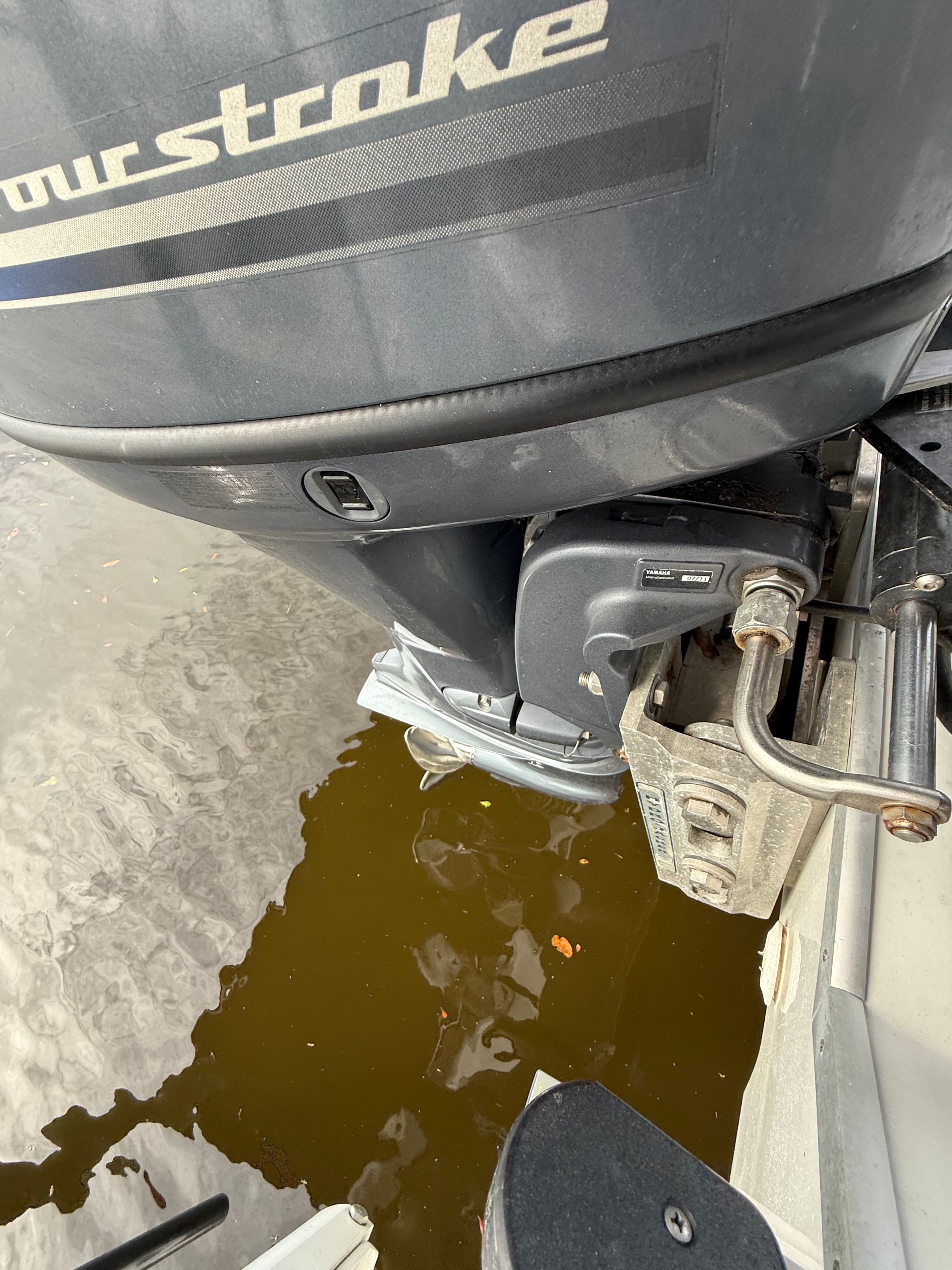 An outboard motor of a boat in the water, partially visible.