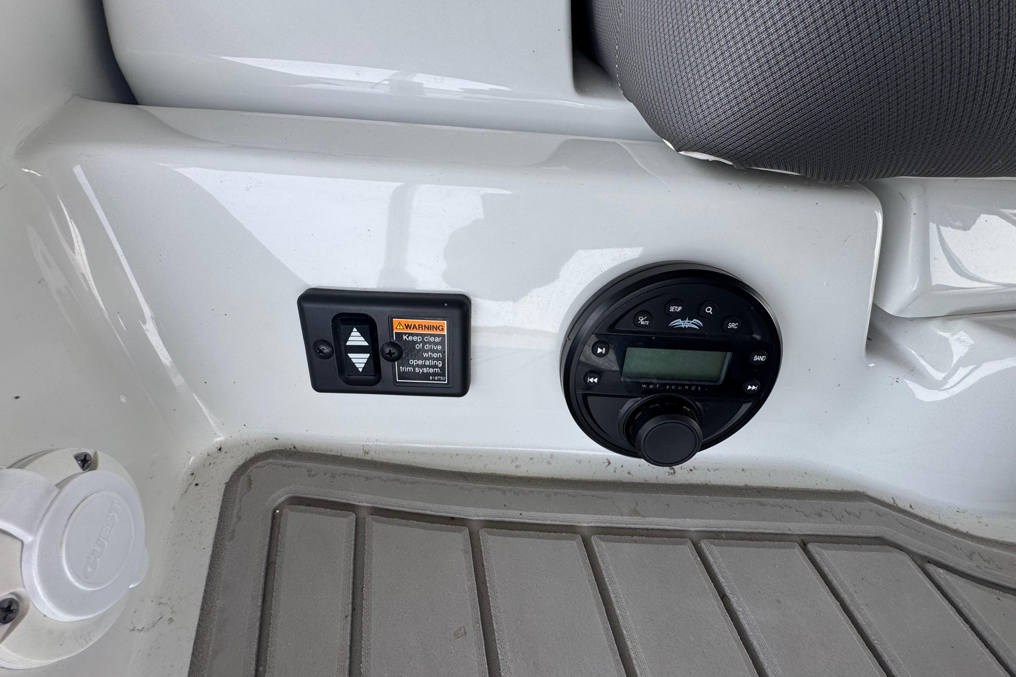2022 Crownline 265 SS boat control panel with warning label and audio system.