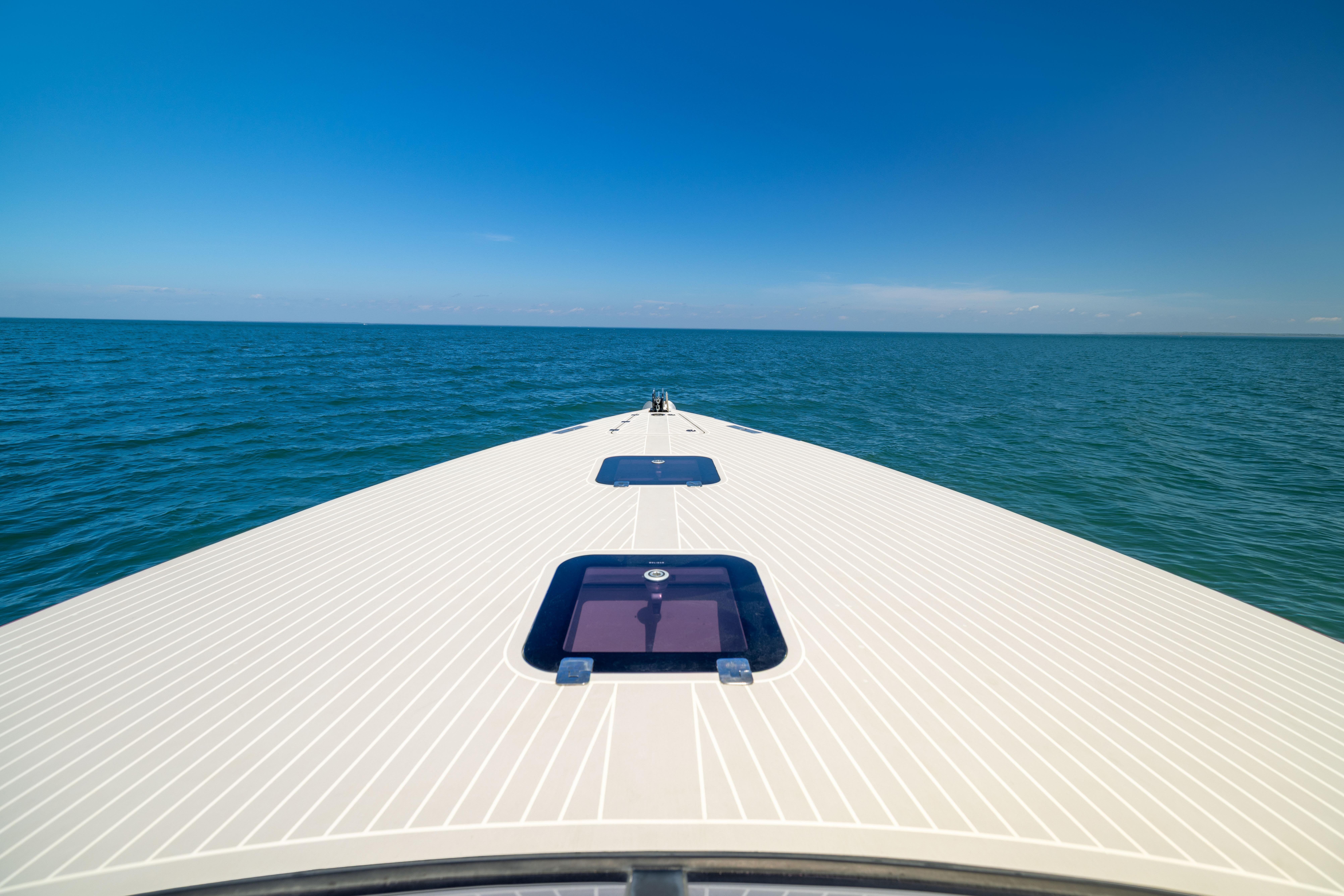 VanDutch 40 yacht cruising on open sea under clear blue sky, 2016 model.