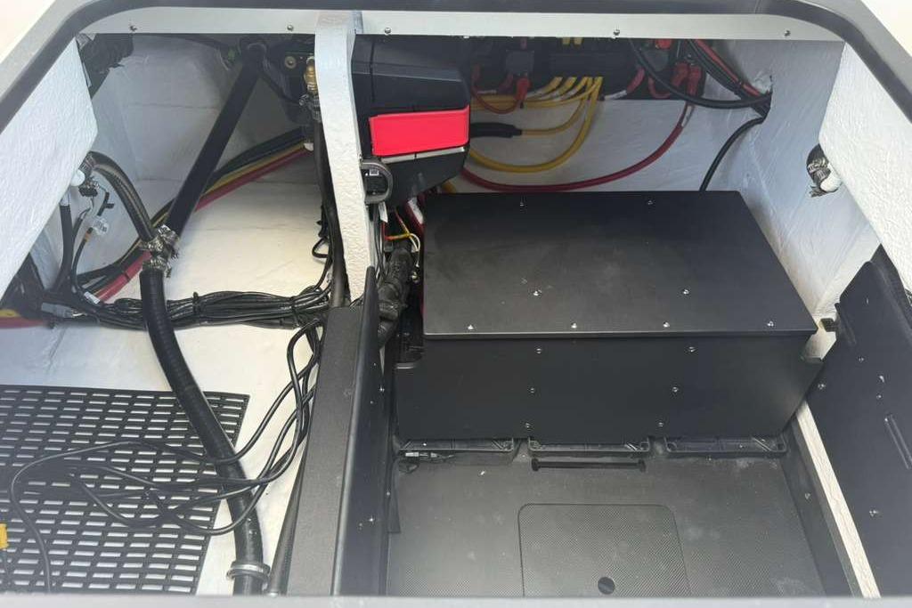 Engine compartment of 2026 Monterey Elite 30 OB boat, showcasing wiring and components.