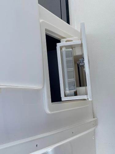 2023 Robalo R270 storage compartment with clear container.