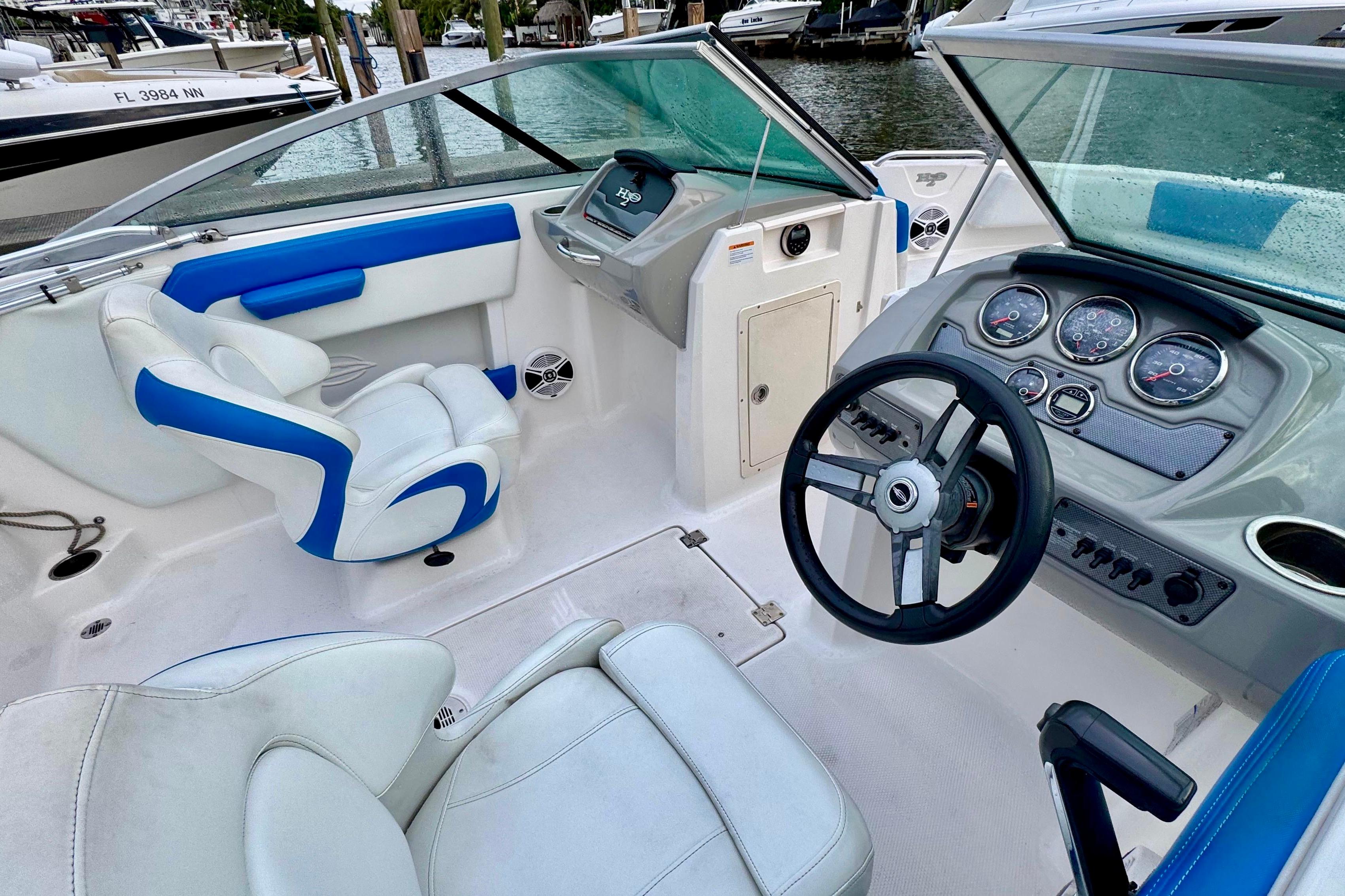 2018 Chaparral 21 H2O Sport boat interior with steering wheel and seating.