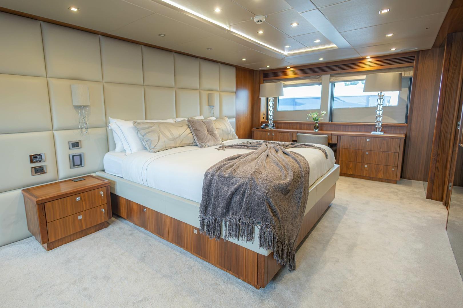 Luxurious bedroom interior on a 2014 Sunseeker 131 Yacht, featuring elegant wood finishes and plush bedding.