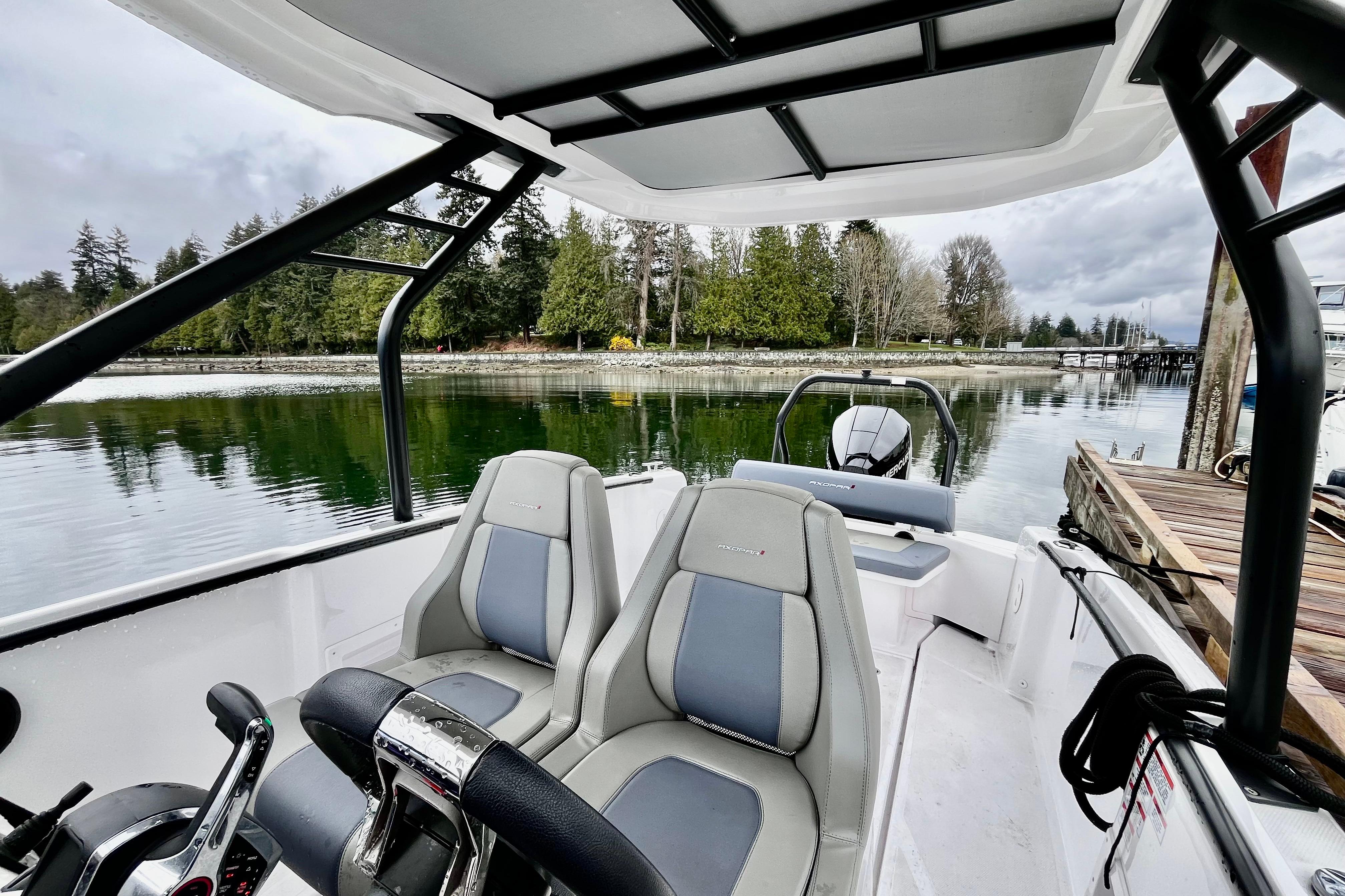 2023 Axopar 22 T-Top boat interior with scenic waterfront view.