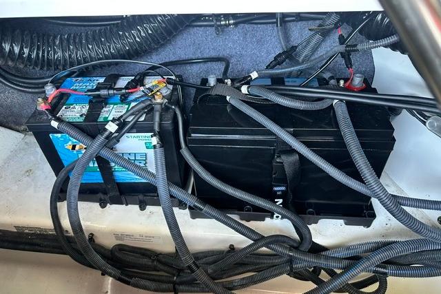 2021 Yamaha Boats 275SD battery compartment with wiring and connections.