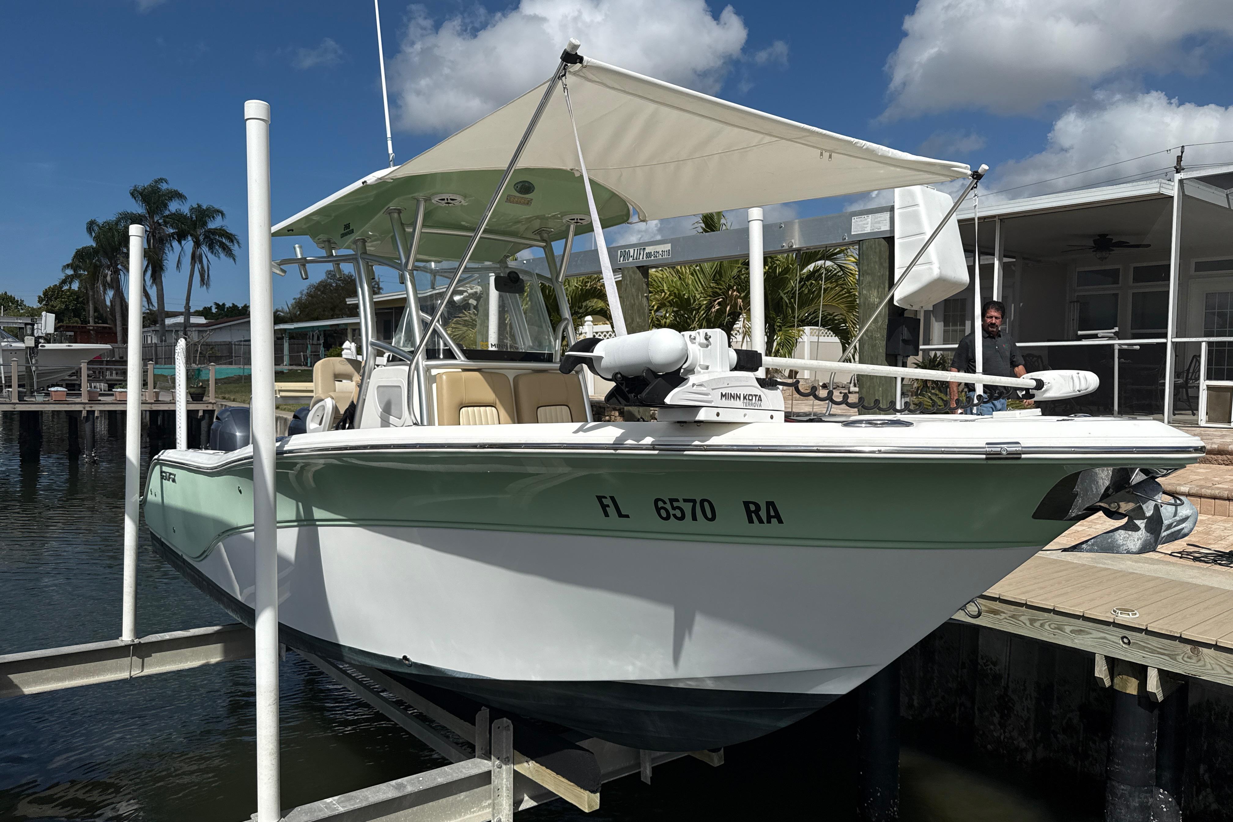 2016 Sea Fox 266 Commander boat docked, featuring a canopy and Minn Kota trolling motor.