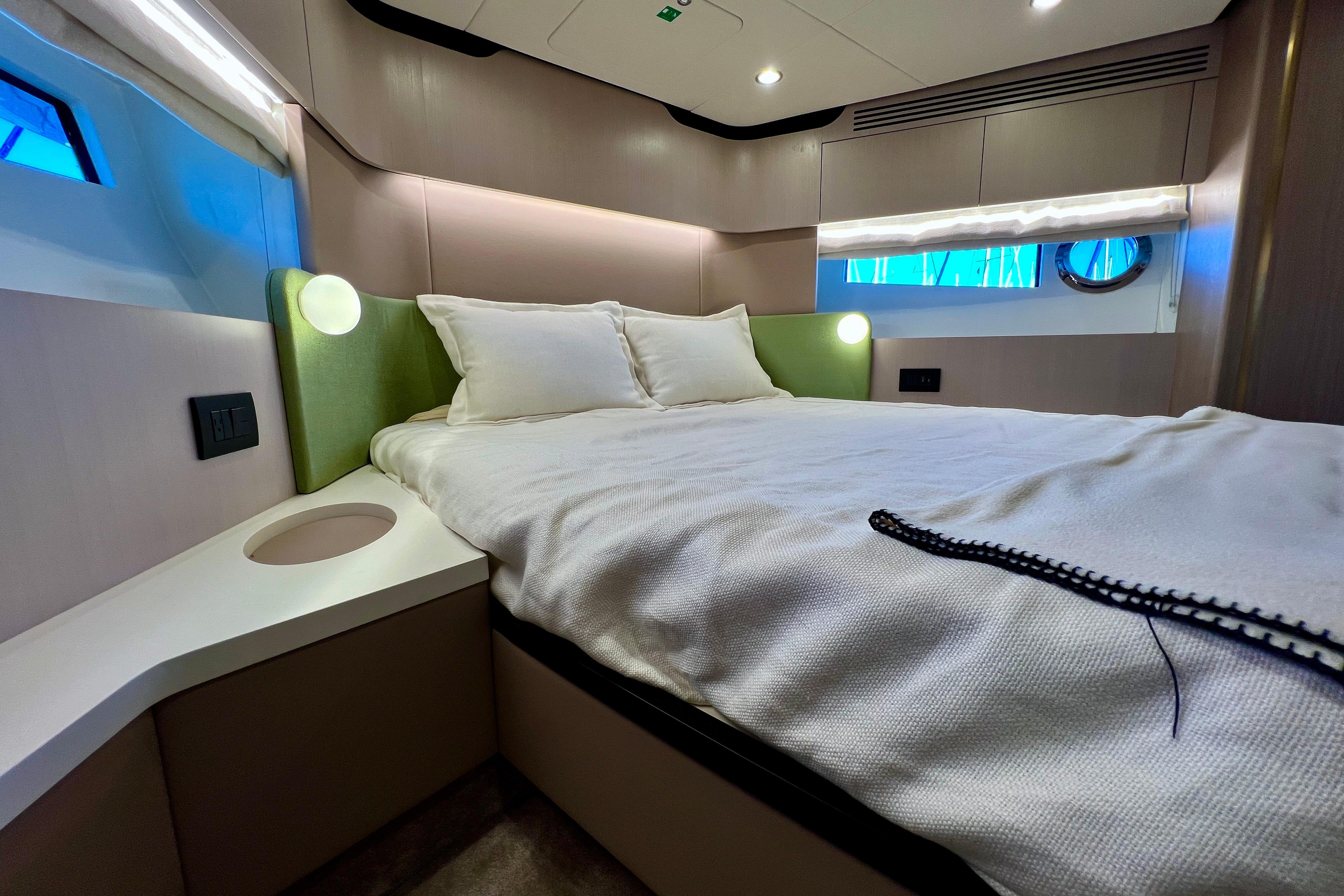 Luxurious bedroom interior of 2024 Azimut Fly 60 yacht with modern design.