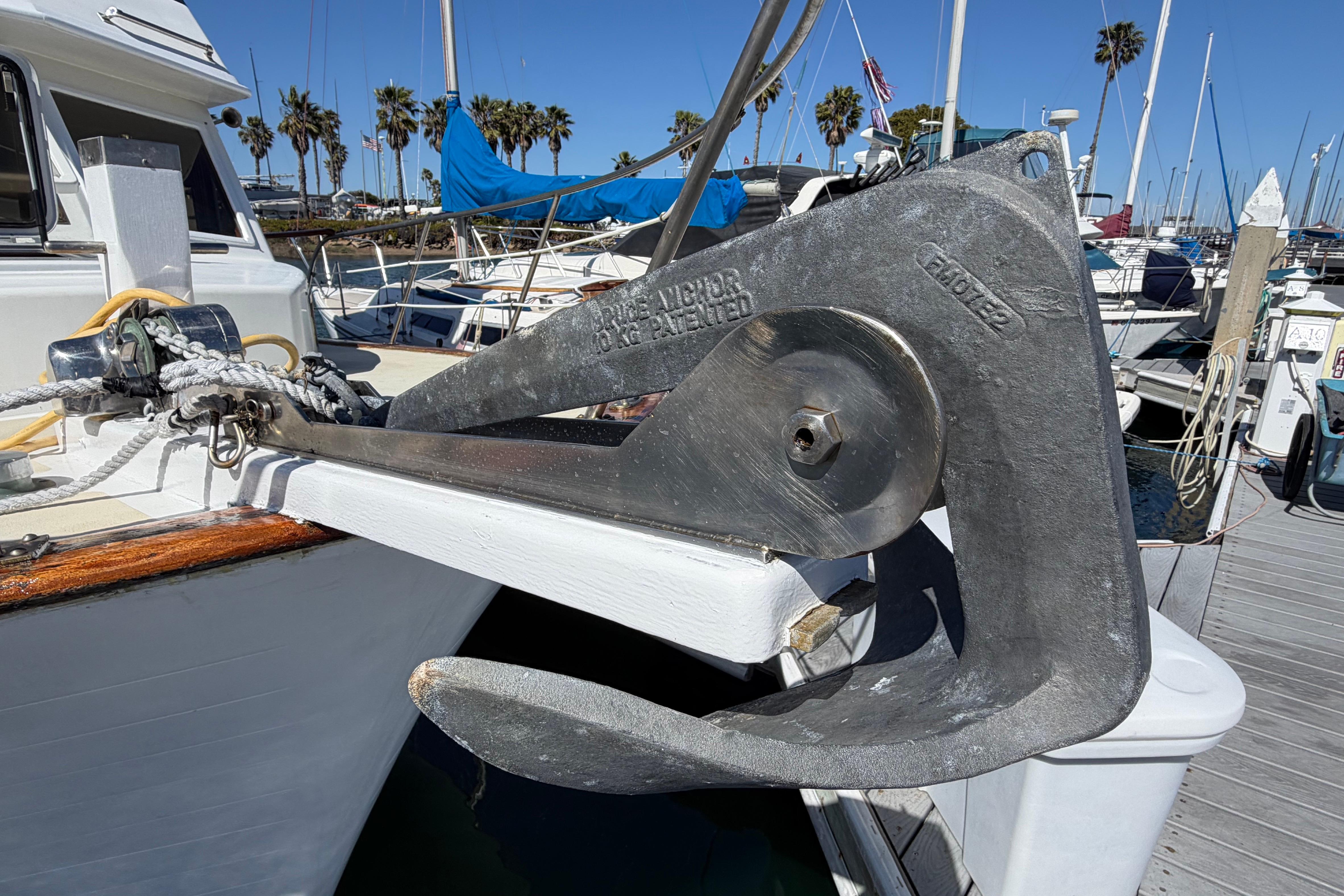 Anchor on 1982 Lien Hwa 31 boat, docked at marina with palm trees.