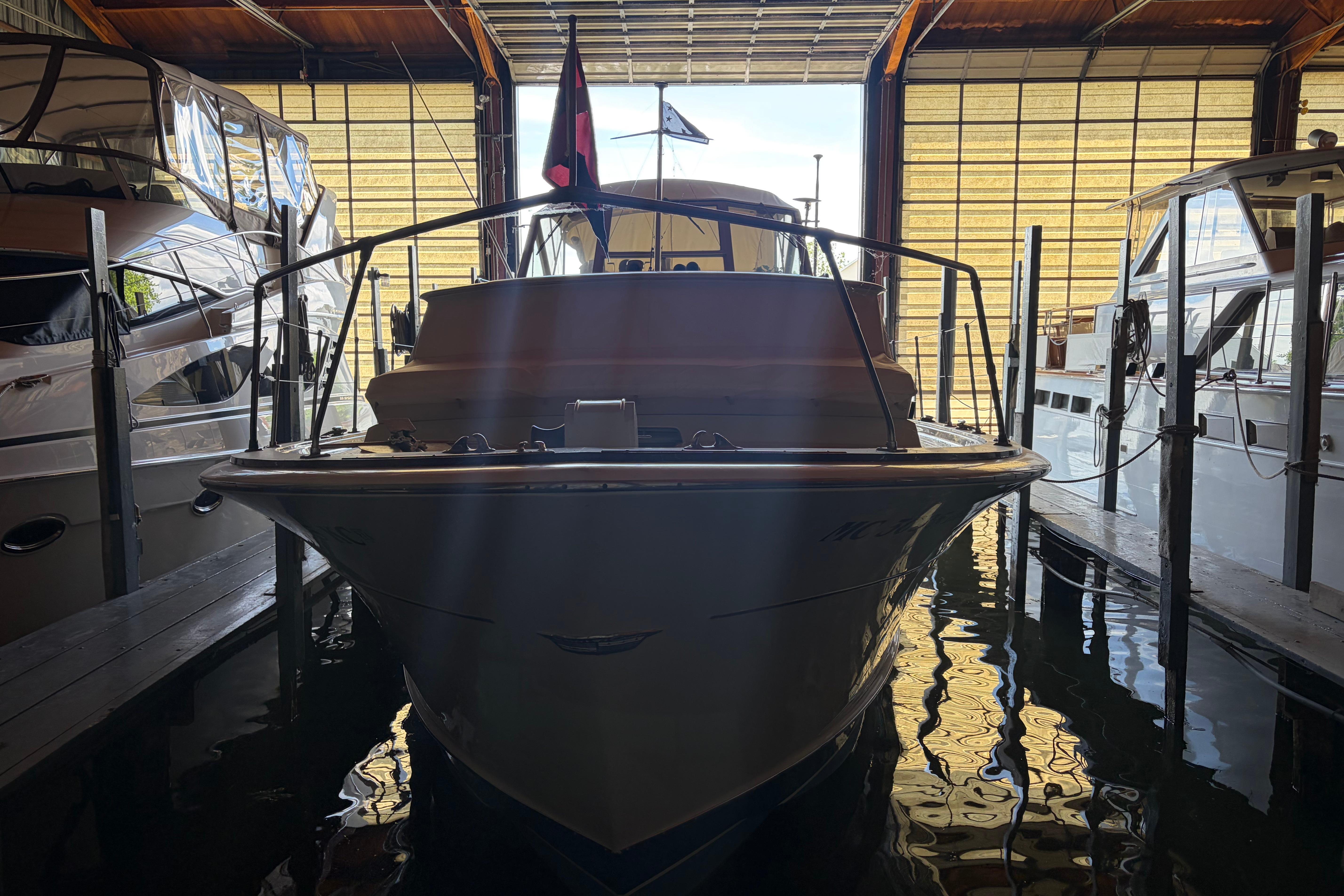 1971 Chris-Craft 42 Commander docked in a marina, front view.