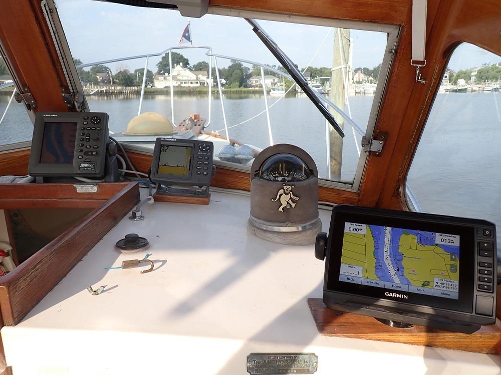 1983 Dyer 29 Downeast Express boat cockpit with navigation equipment and scenic water view.