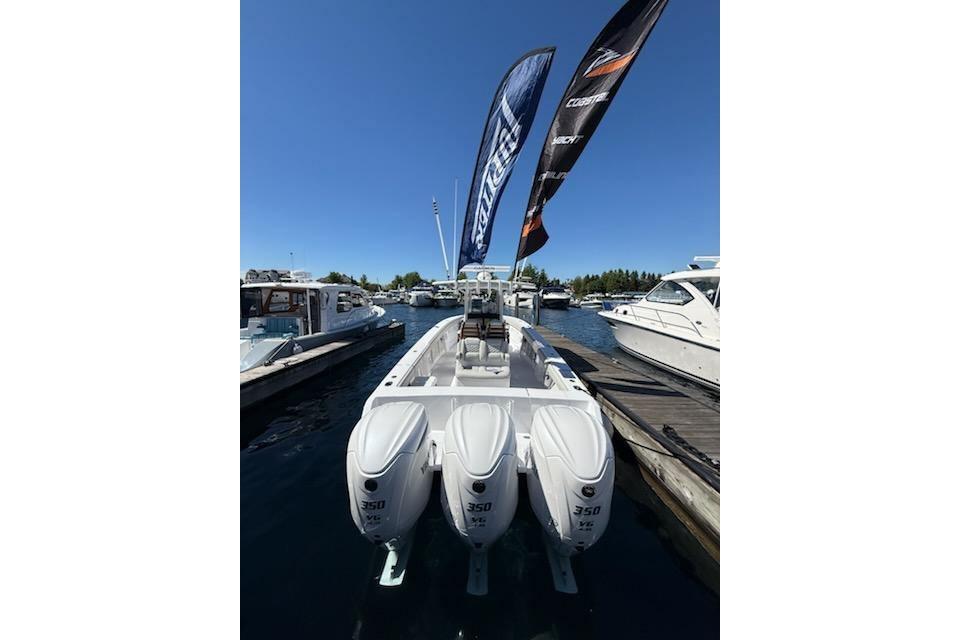 2026 Jupiter 340LS boat with triple 350 engines docked at marina.