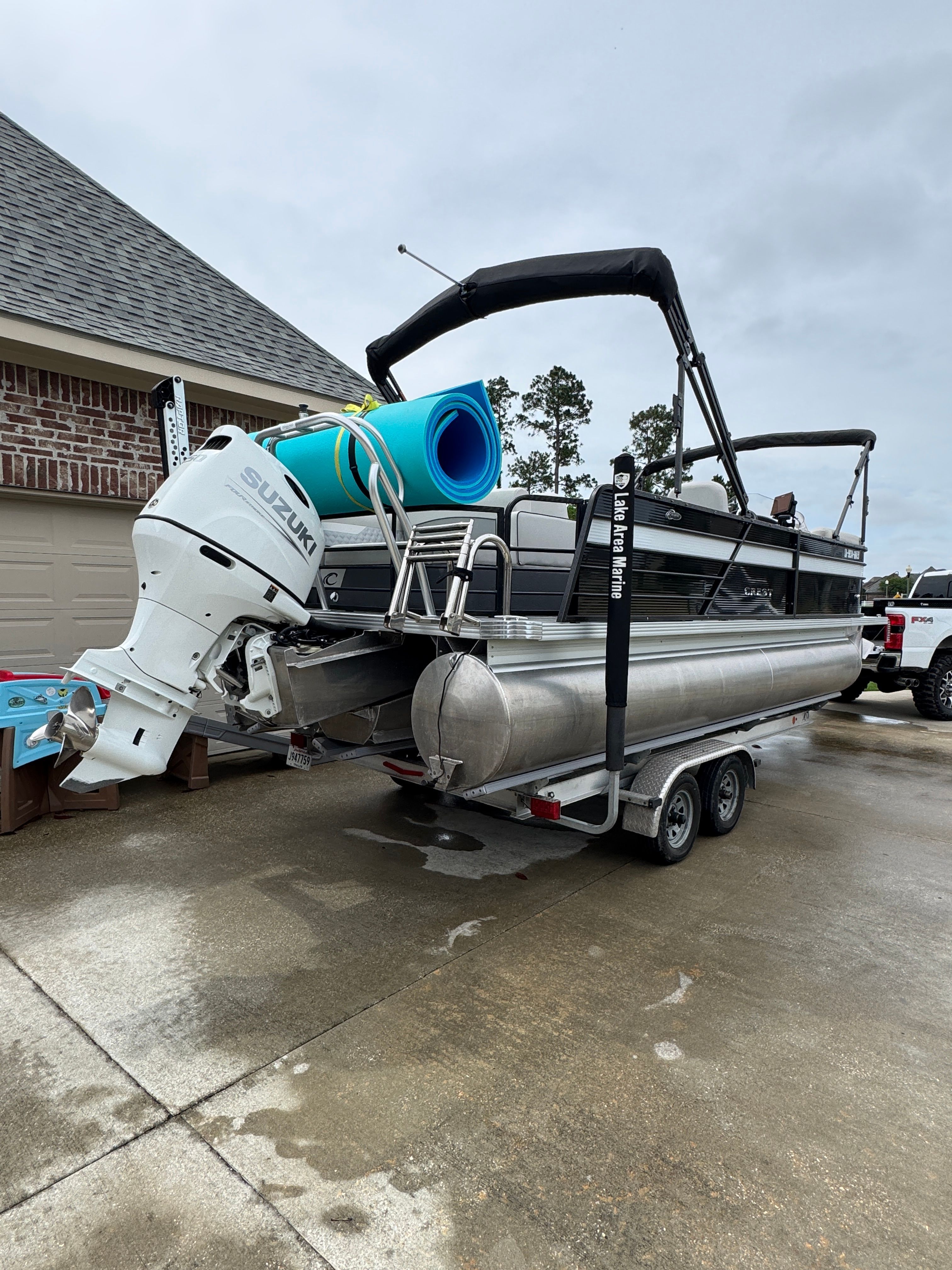 2022 Crest Classic DLX 220 pontoon boat parked on trailer.
