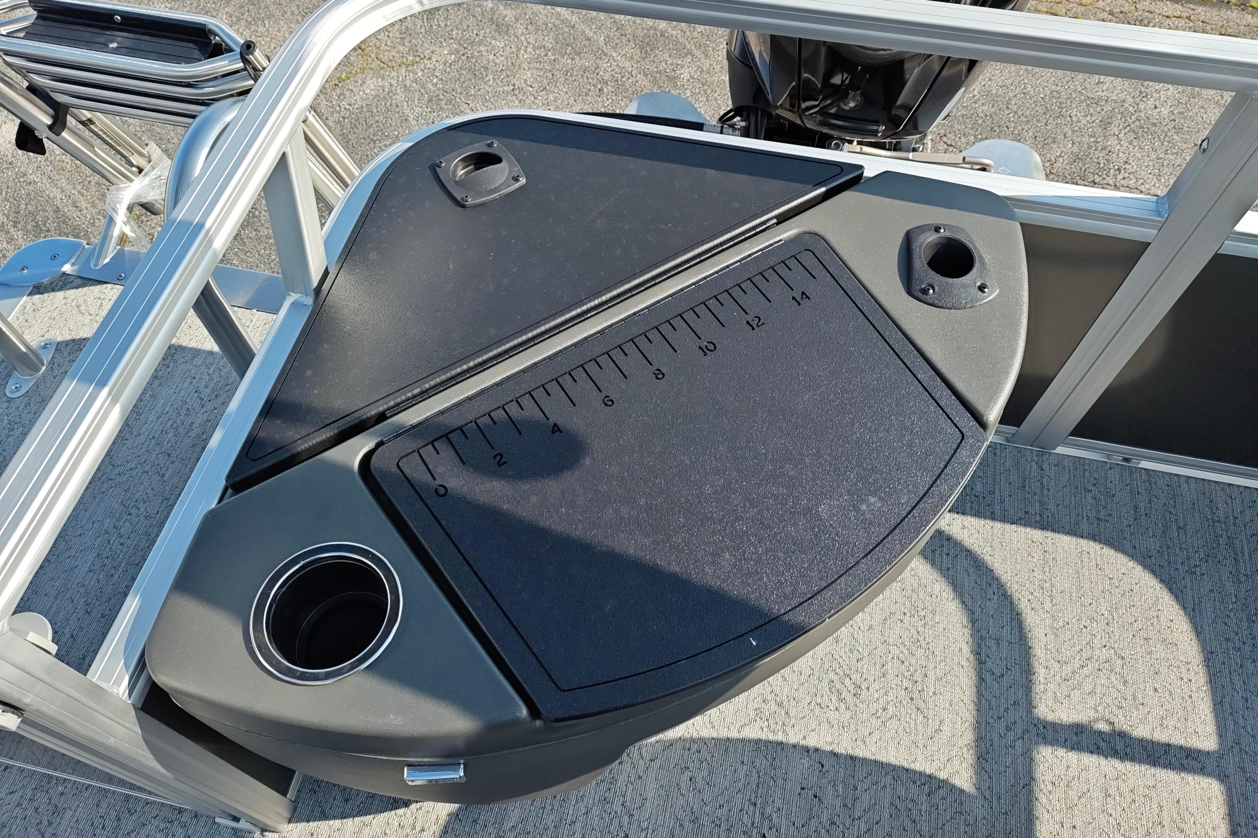 2026 Sun Tracker Bass Buggy 18 DLX fishing station with measuring board and cup holders.