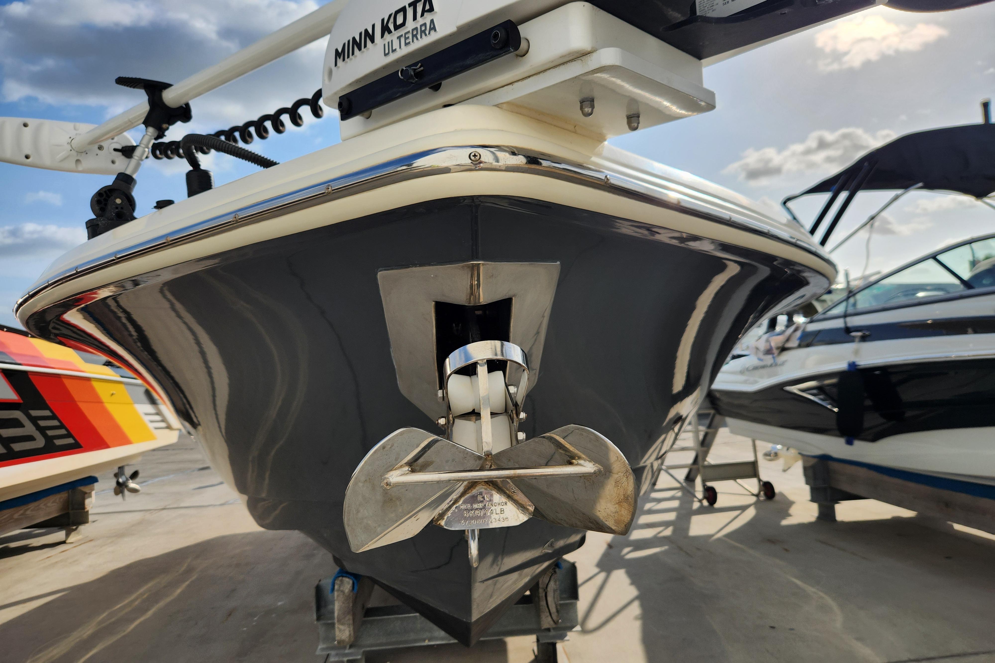 2024 Scout 281 XSS boat with Minn Kota Ulterra motor, docked under a sunny sky.