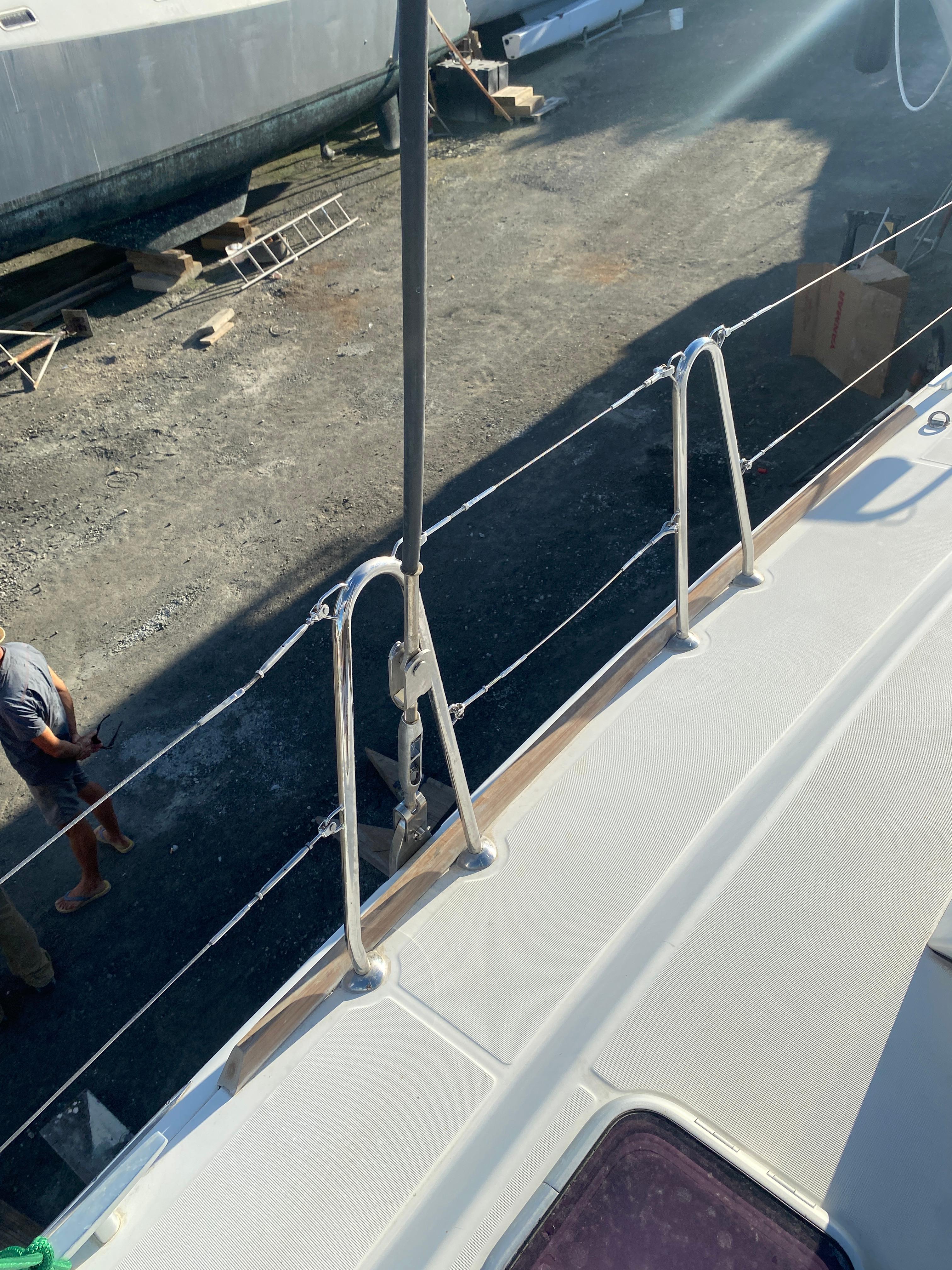 Lagoon 380 catamaran deck view, 2013 model, in a boatyard setting.