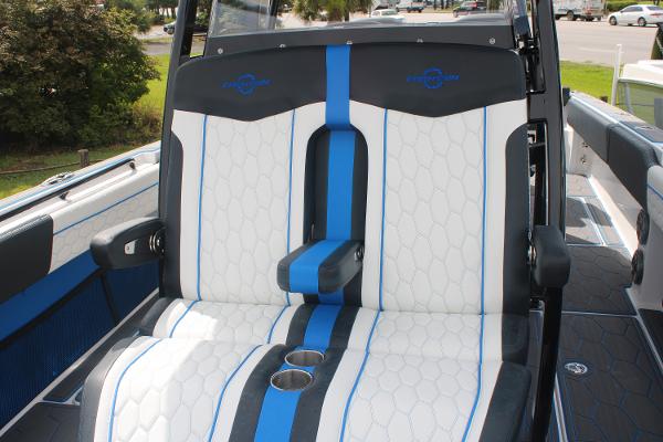 2024 Fountain 34 SC boat seats with blue and white upholstery, featuring cup holders.