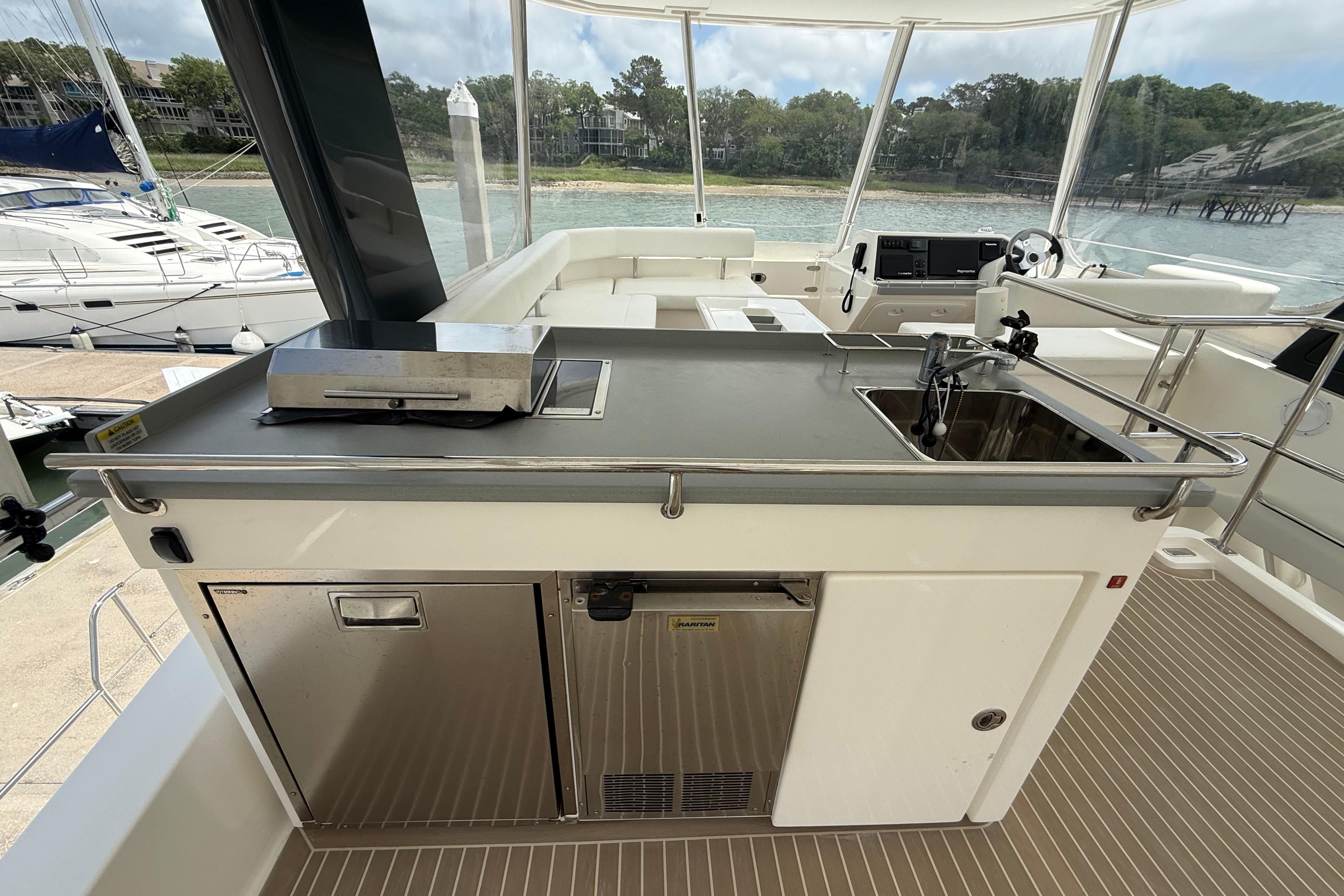 Outdoor kitchen on a 2021 Leopard 43 Powercat yacht with grill and sink.