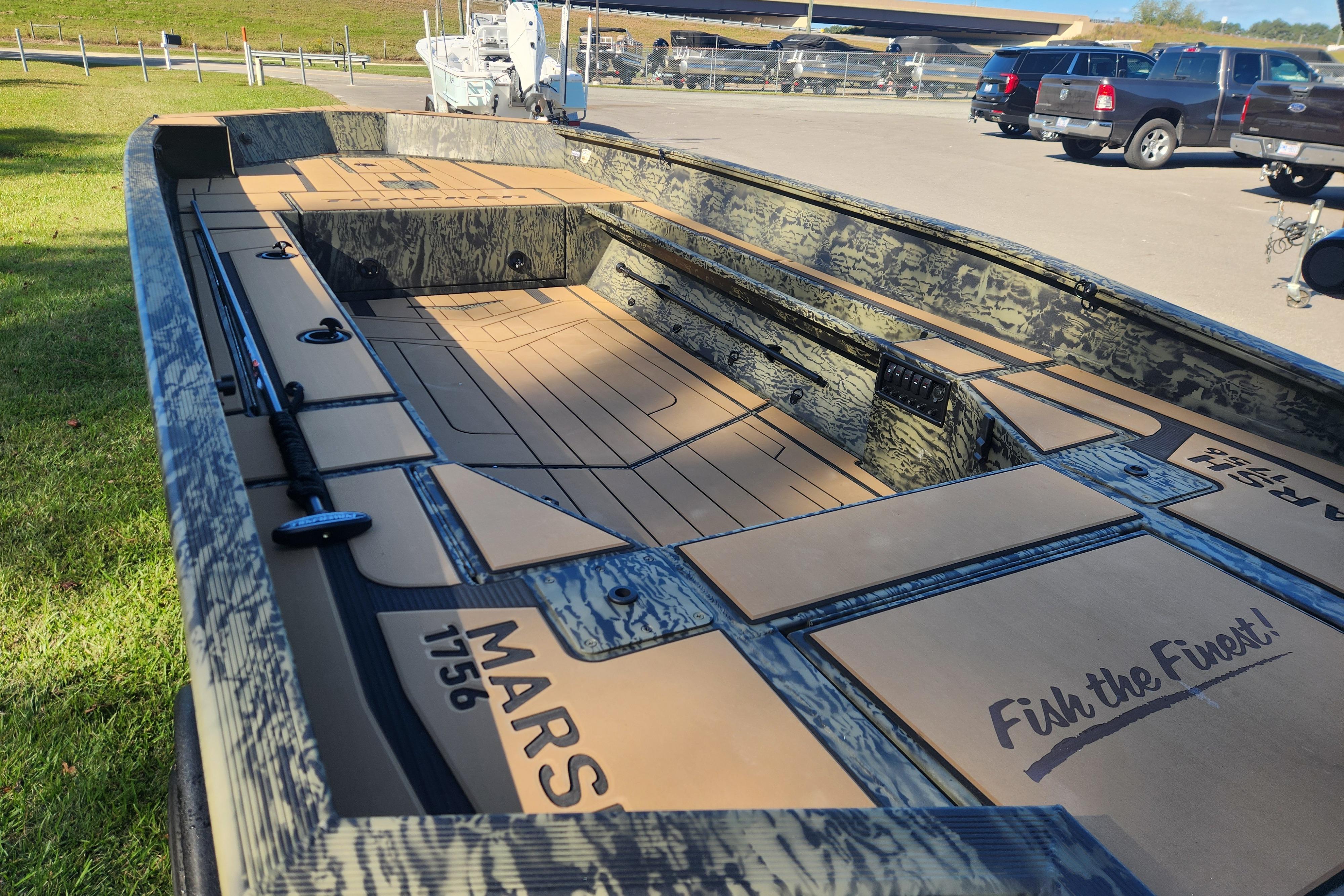 2026 Tracker Grizzly 1756 T Marsh boat with camo design, parked outdoors.