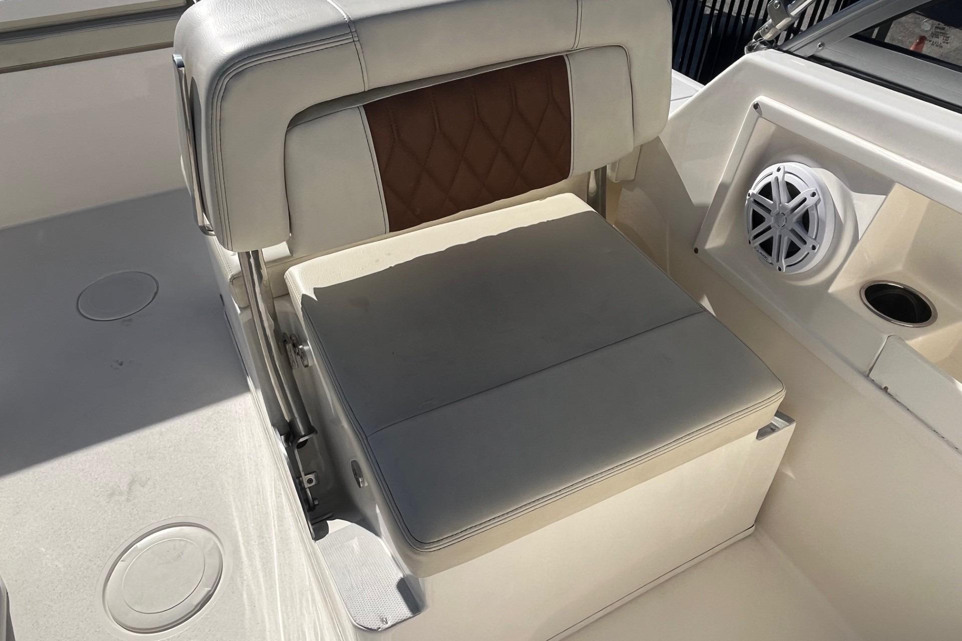 2023 Cobia 220 Dual Console boat seat with speaker and cup holder.