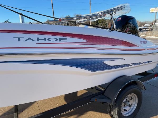 2024 Tahoe T18 boat with red and blue accents on a trailer.