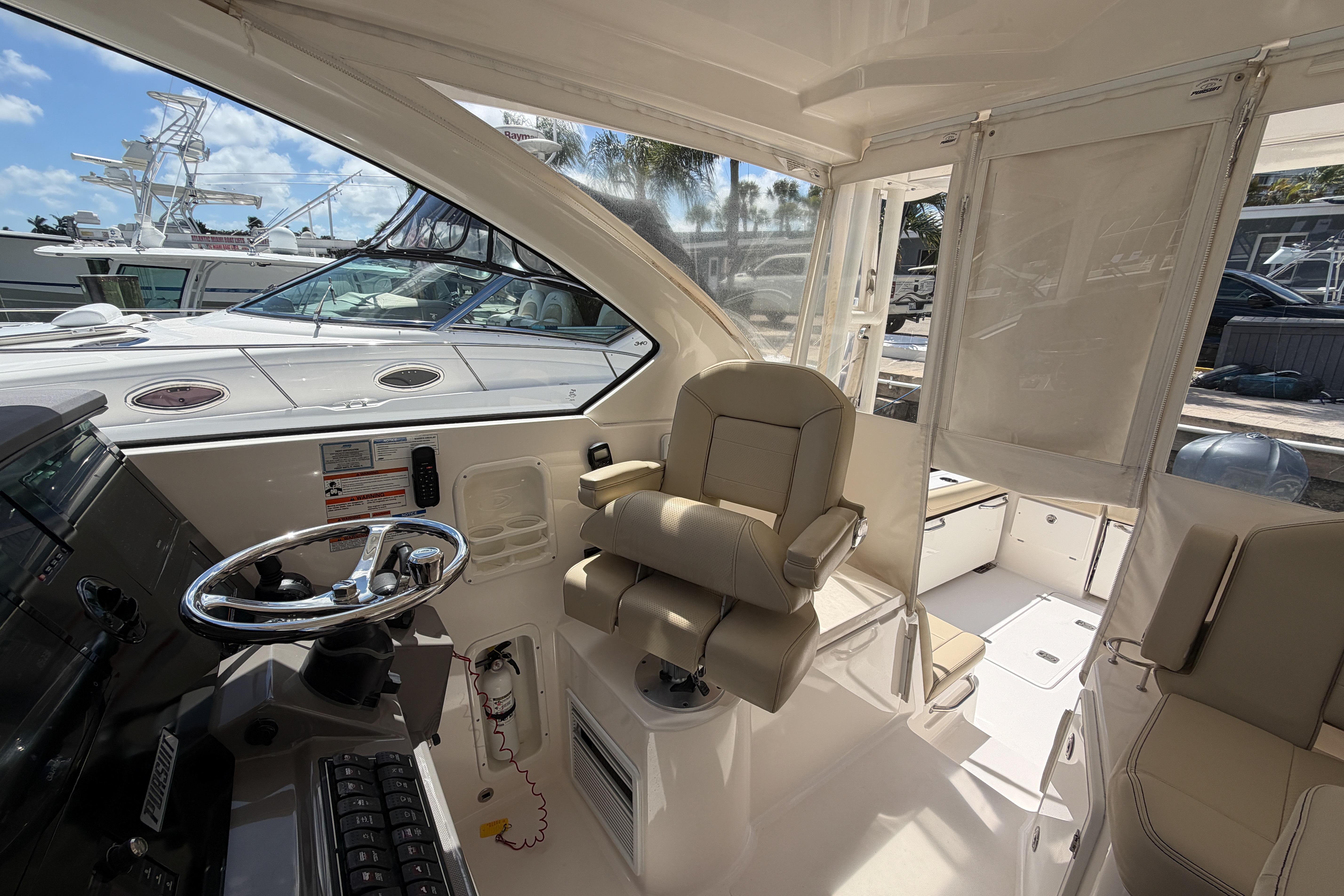 2018 Pursuit OS 355 Offshore boat interior with helm and seating area.