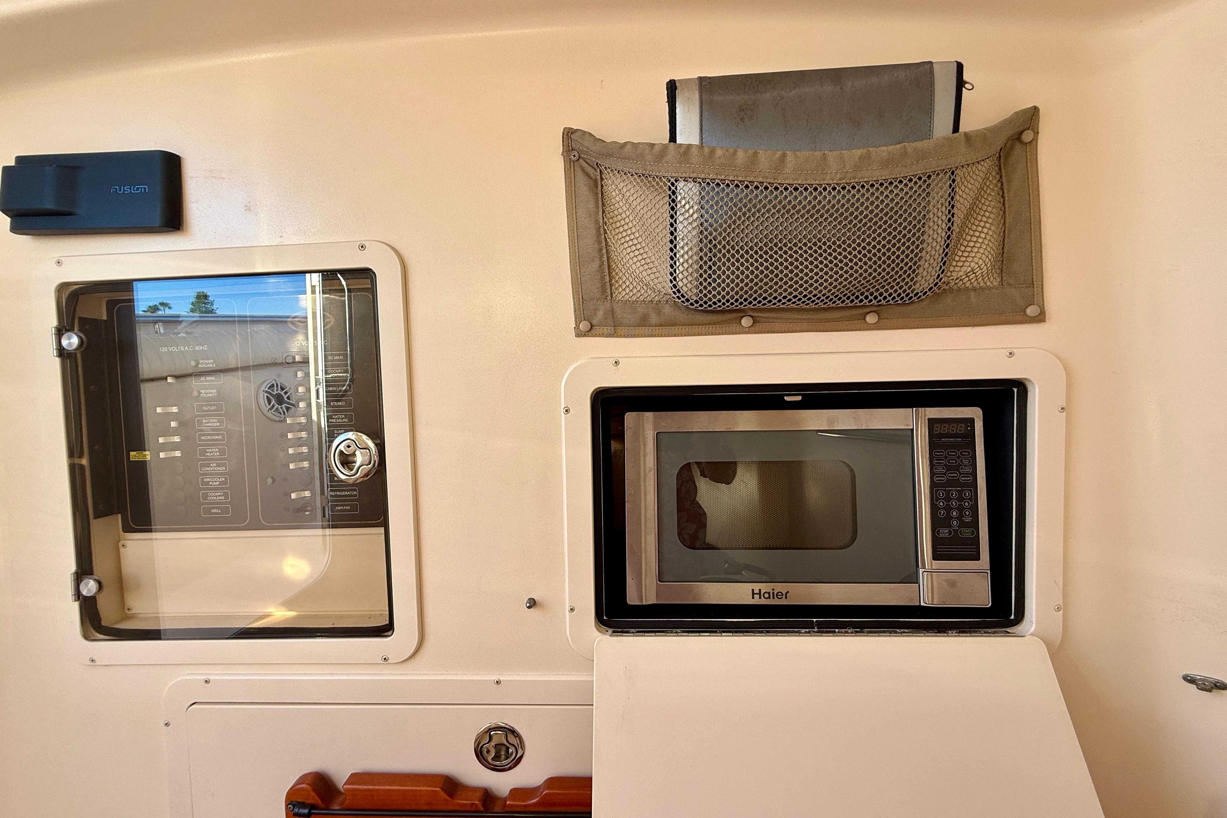 Interior of 2012 Grady-White Canyon 336 featuring a Haier microwave and control panel.
