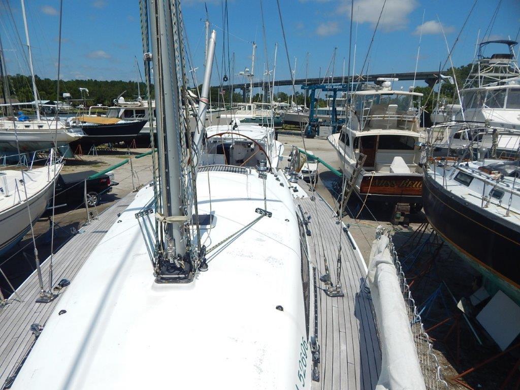 Sailboat docked at marina, Custom 38 C/R, 2003 model, surrounded by other boats.