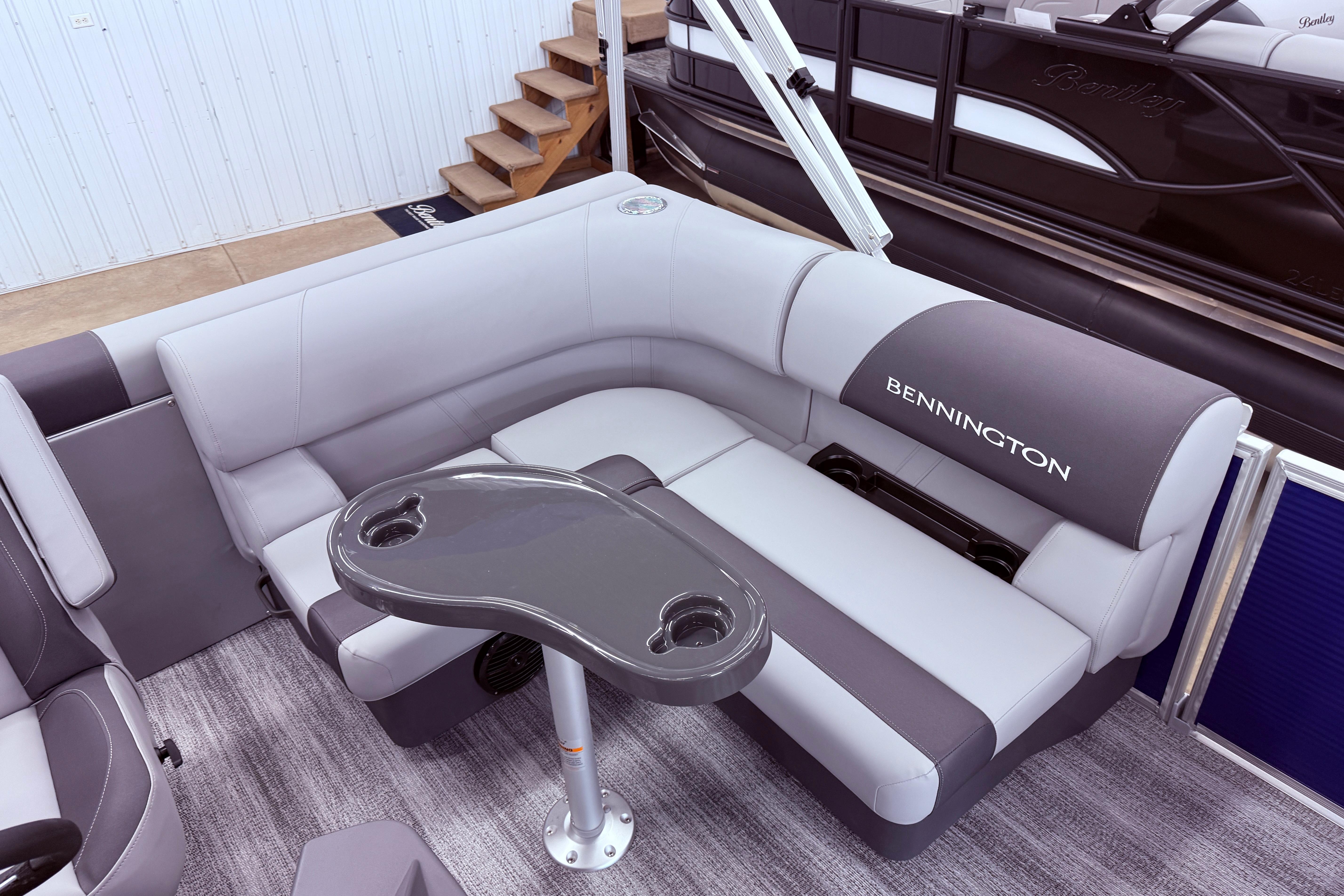2026 Bennington 168 SLJ Electric pontoon boat interior with plush seating and table.
