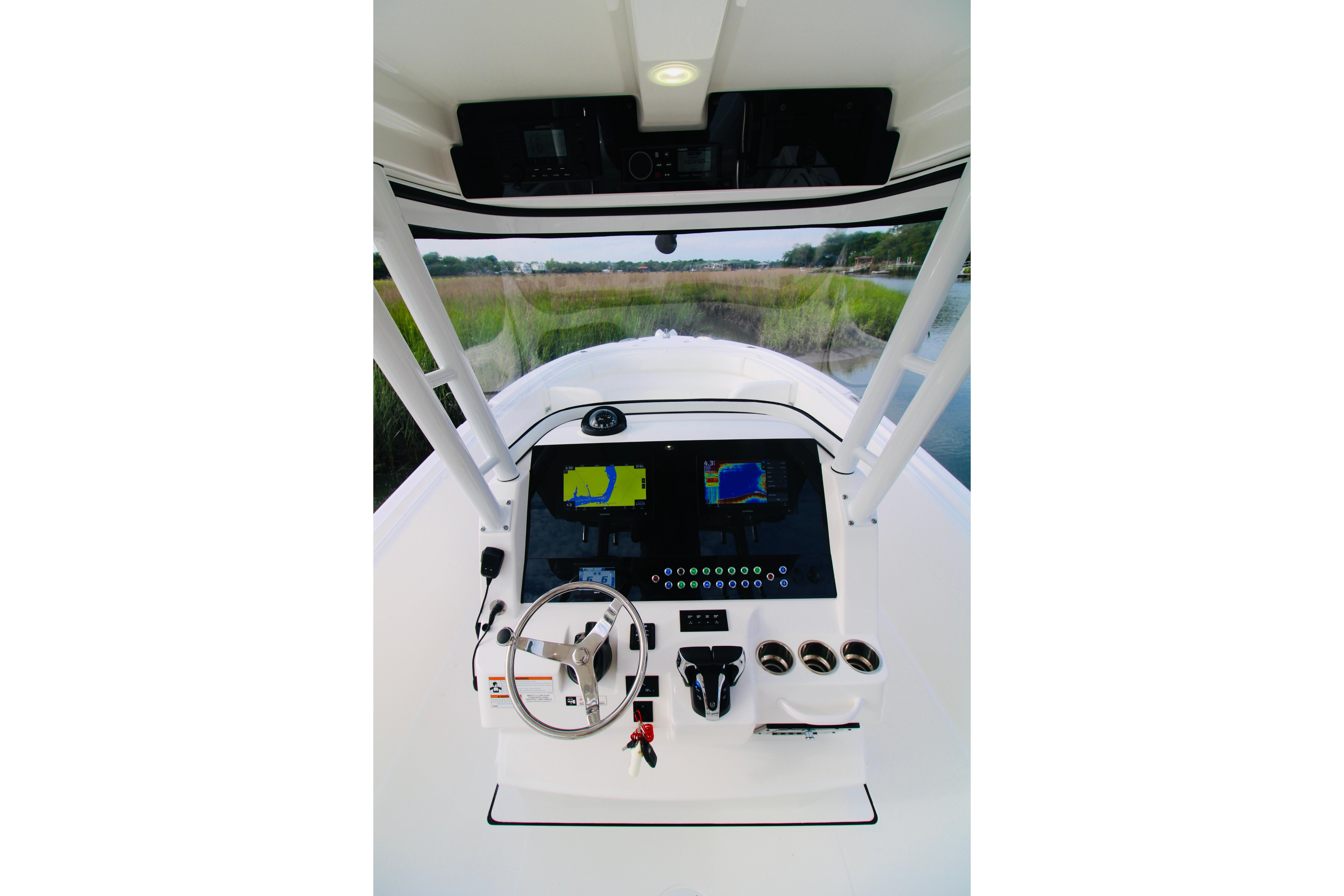 2022 Edgewater 280CC boat dashboard with navigation screens and steering wheel.
